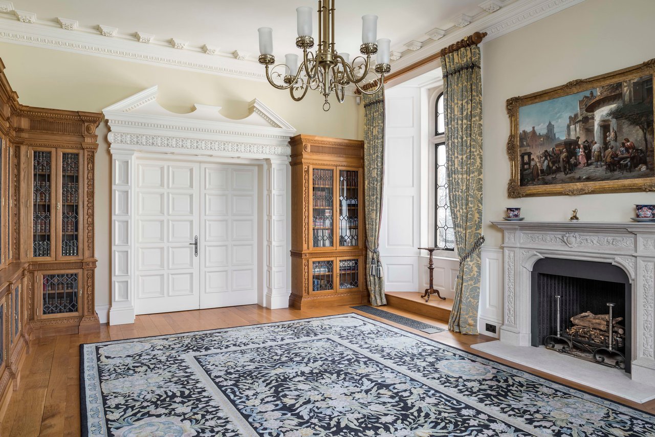 Extensive fitted hand-carved bookshelves