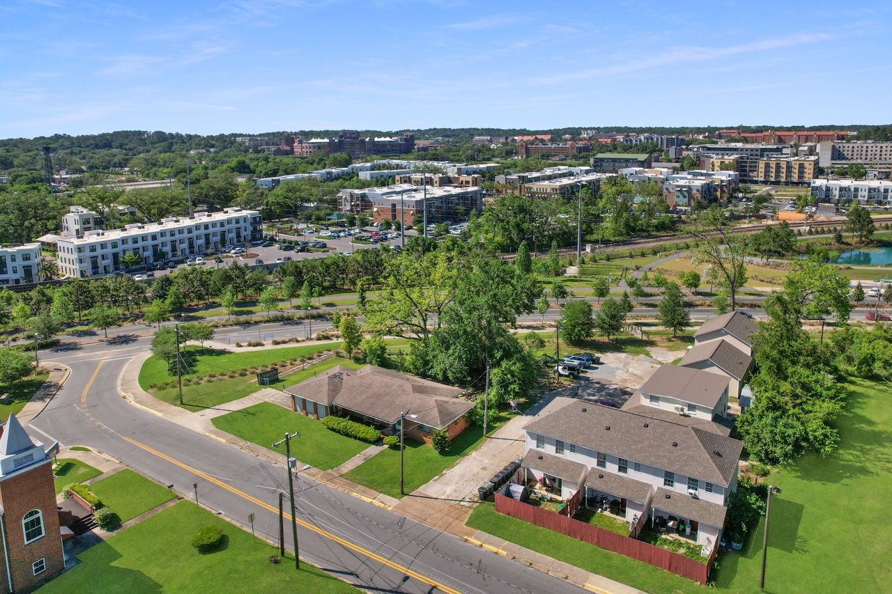 Aerial view of  Villa Mitchell highlighting the layout of the buildings, streets, and surrounding greenery.