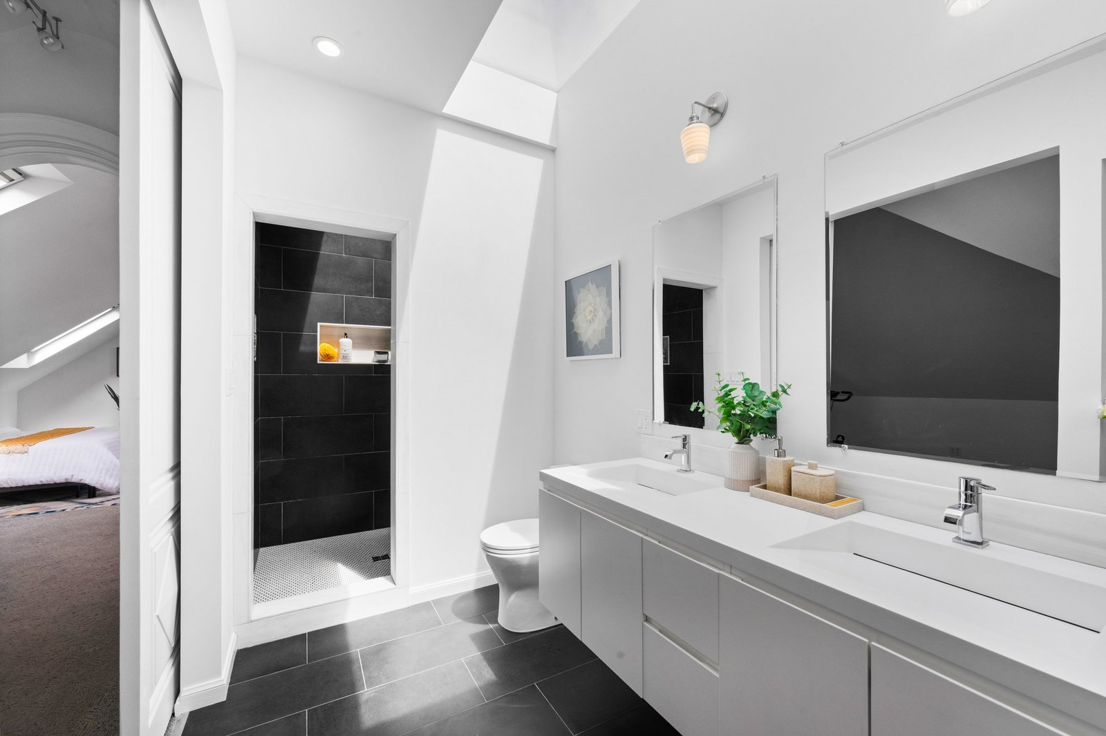 Skylit walk-in shower and double vanity in the primary bath at 449 Frederick Street, Cole Valley