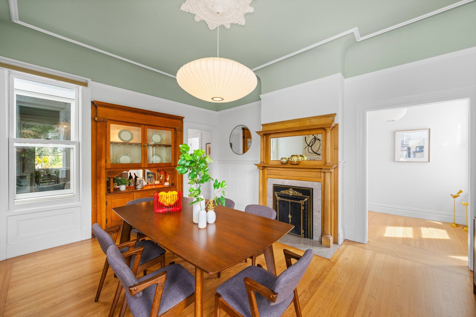 Formal dining room with built-in china cabinet and decorative fireplace at 449 Frederick Street