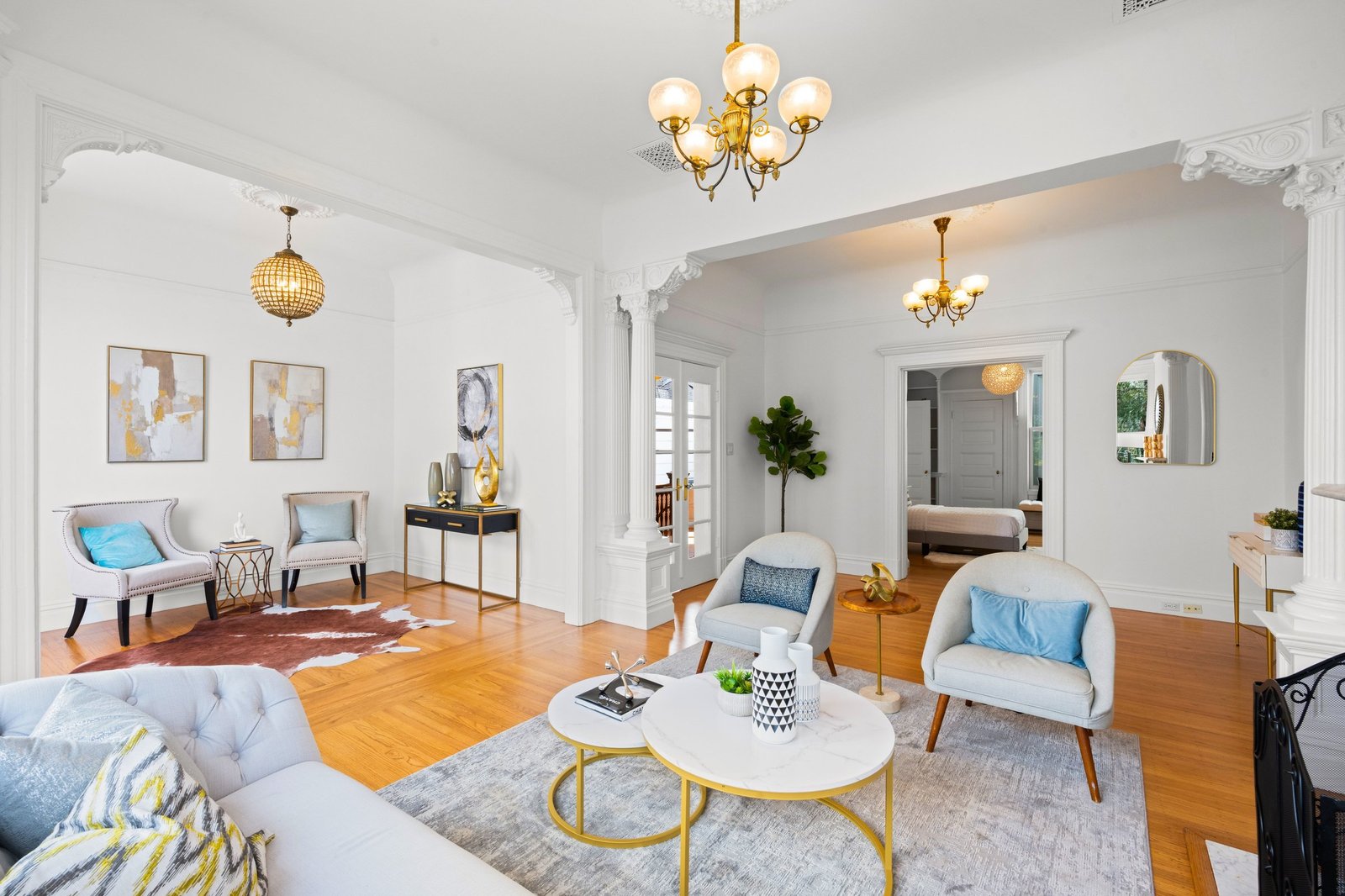 Double parlor living room with two chandeliers looking through to the bedroom at 449 Frederick Street