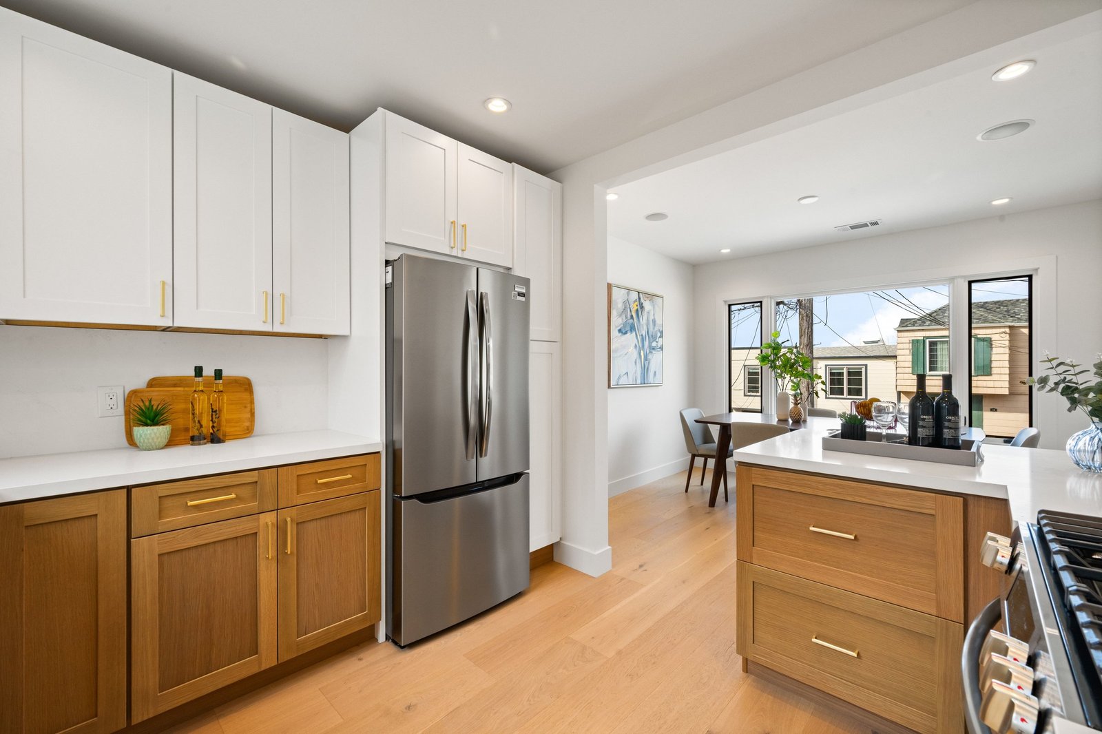 Kitchen with wood cabinetry, white uppers and stainless refrigerator at 15 Shields Street