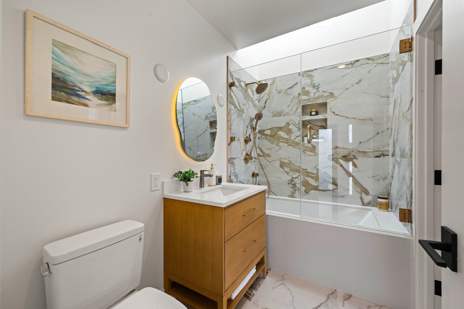 Bathroom with marble-look tile, tub and Velux skylight at 15 Shields Street