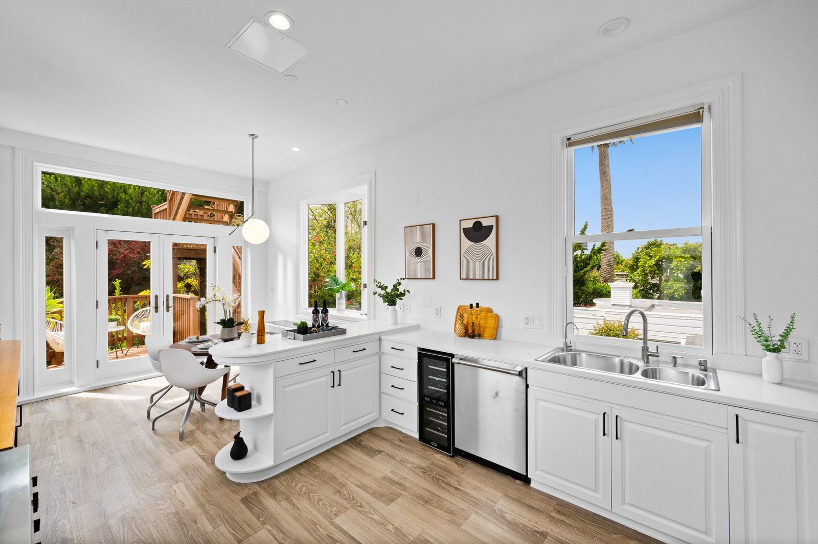 Kitchen with island, quartz counters and French doors to the deck at 449 Frederick Street, Cole Valley