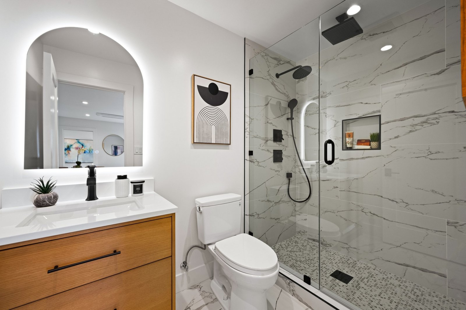 Ground-floor unit bathroom with frameless glass shower and floating vanity at 15 Shields Street
