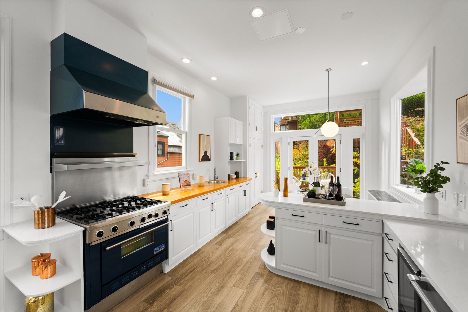 Viking range with navy hood and butcher block counter in the kitchen at 449 Frederick Street