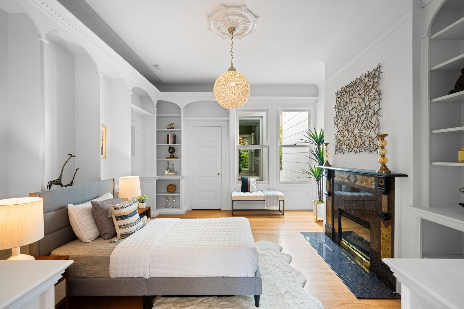 Second bedroom with fireplace and built-in shelving at 449 Frederick Street, Cole Valley