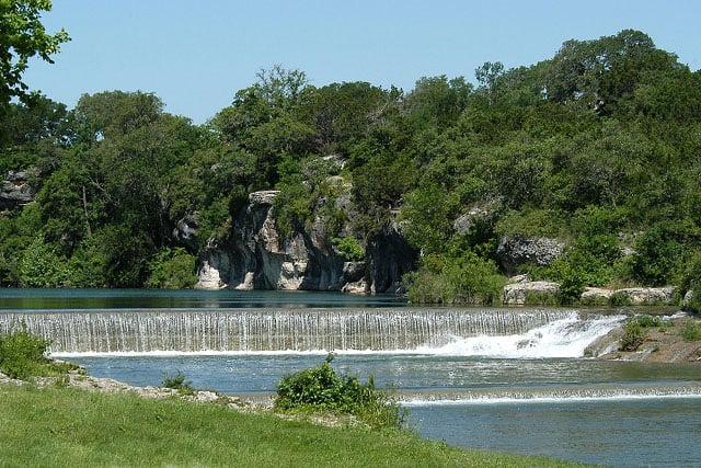 Green water lagoon below limestone bluffs at Blue Hole Park in Georgetown