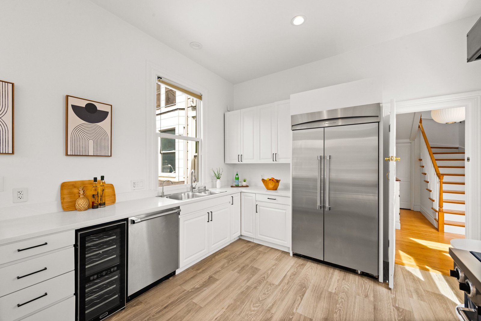 Thermador appliances and wine refrigerator along the kitchen run at 449 Frederick Street