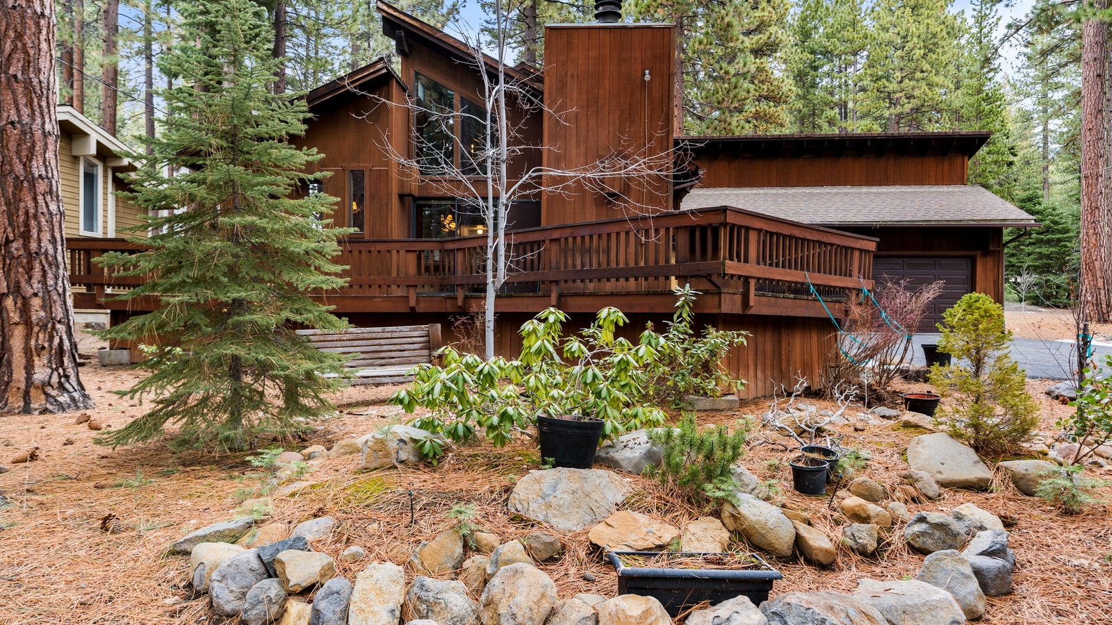 Cedar-sided single-family home with decks and a rock garden among the pines at 1090 Mill Creek Road, Incline Village