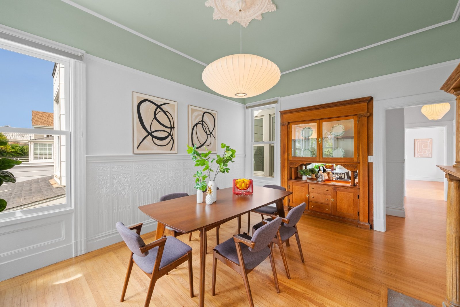 Dining room set for eight beneath a pendant light at 449 Frederick Street, San Francisco
