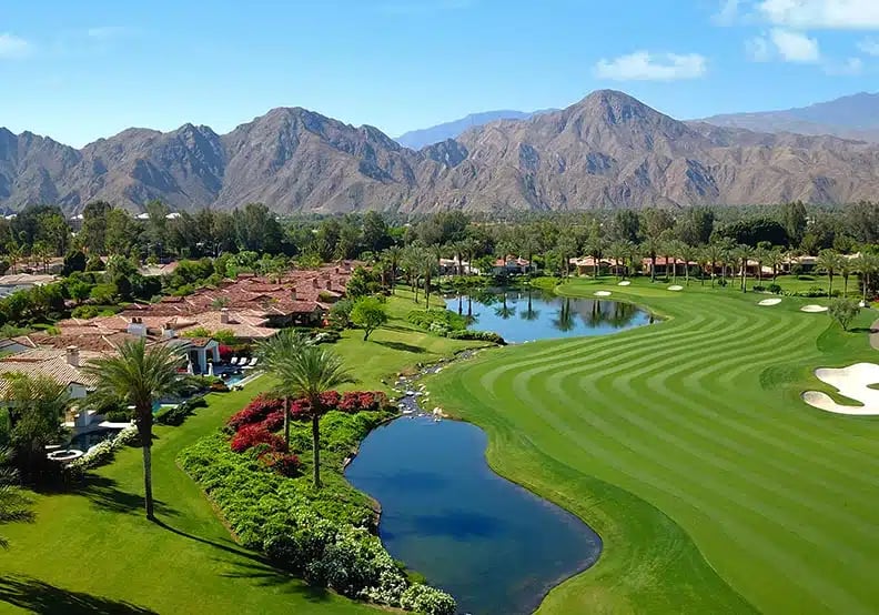 Golf course fairways, lakes and the Santa Rosa Mountains at Toscana Country Club in Indian Wells