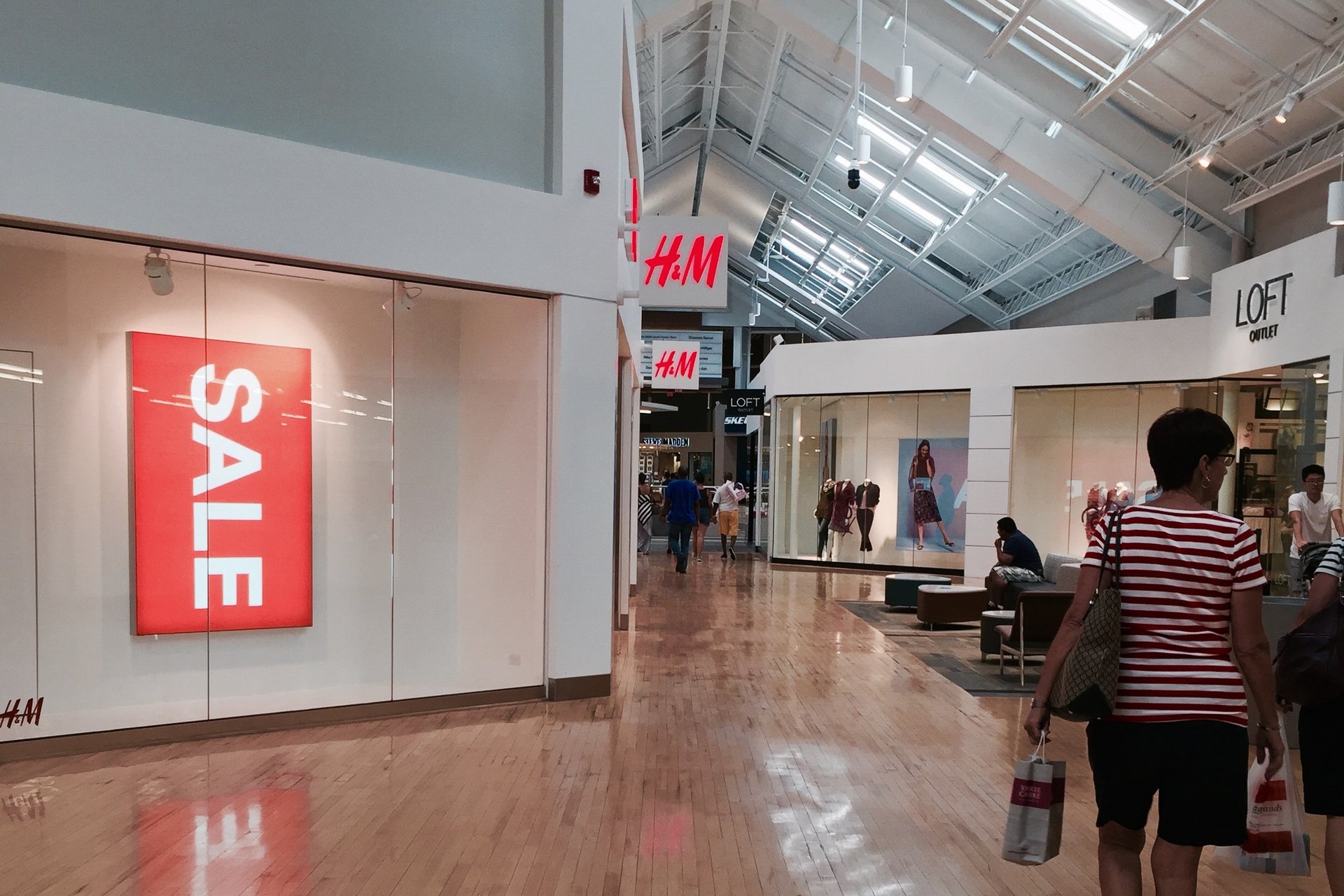 Inside Philadelphia Mills, the outlet mall next to Millbrook, with shops along a bright skylit walkway