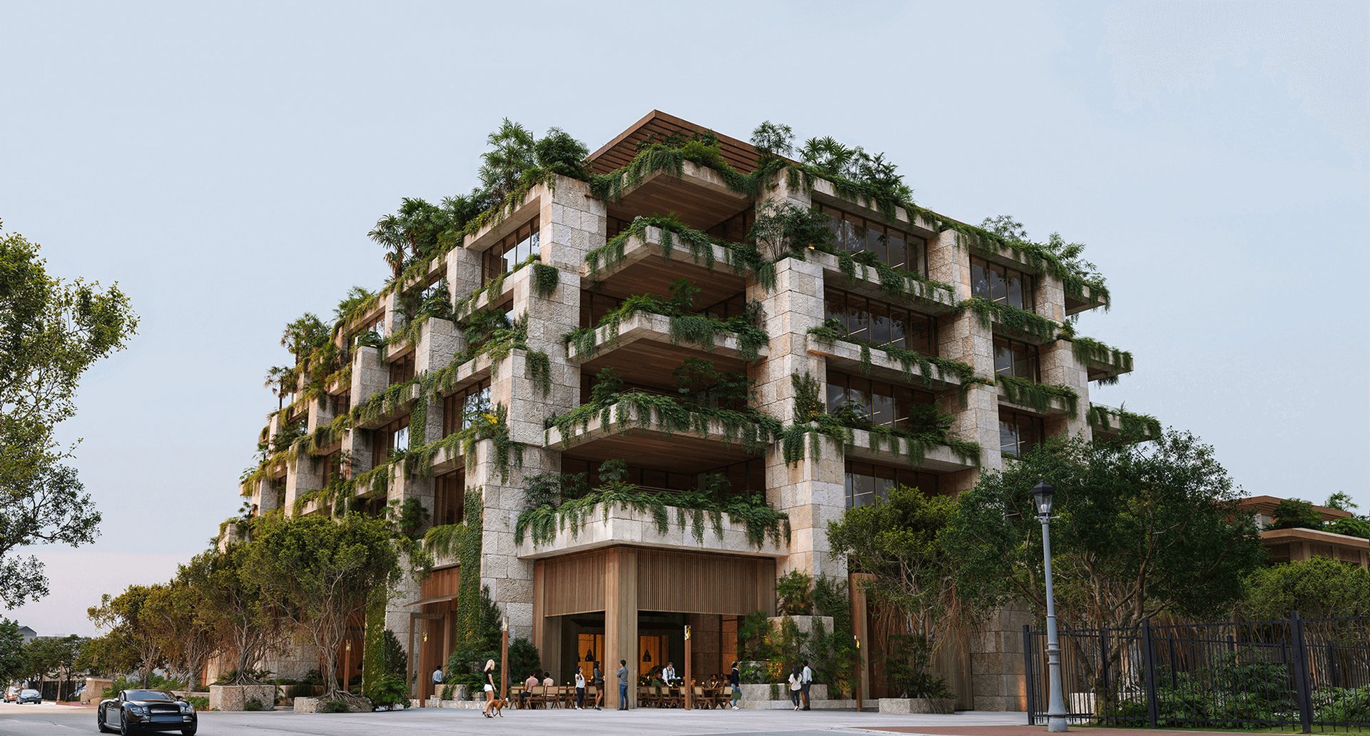 Ziggurat Coconut Grove’s stone-clad residential building with lush planted balconies and a street-level entrance.