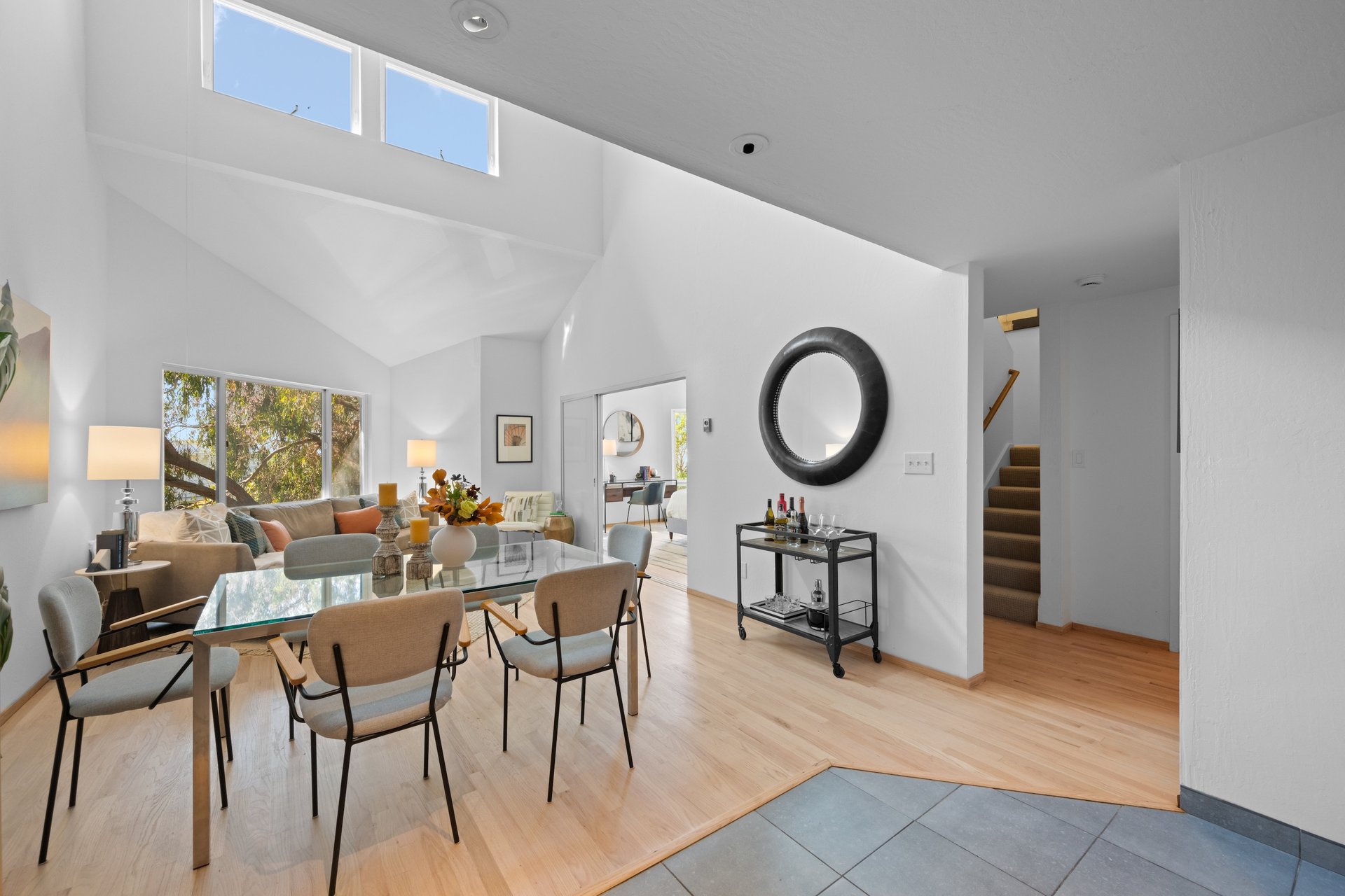 Beautifully staged dining and living room filled with natural light, illustrating how tailored presentation enhances a home&rsquo;s market appeal.
