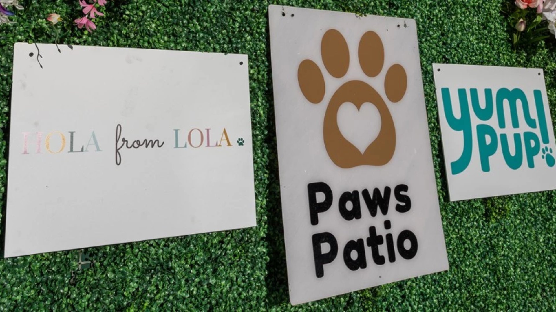 Paws Patio ugly sweater holiday party signage for pet-friendly Miami event featuring Hola from Lola and Yum Pup vendors by The Edit Real Estate