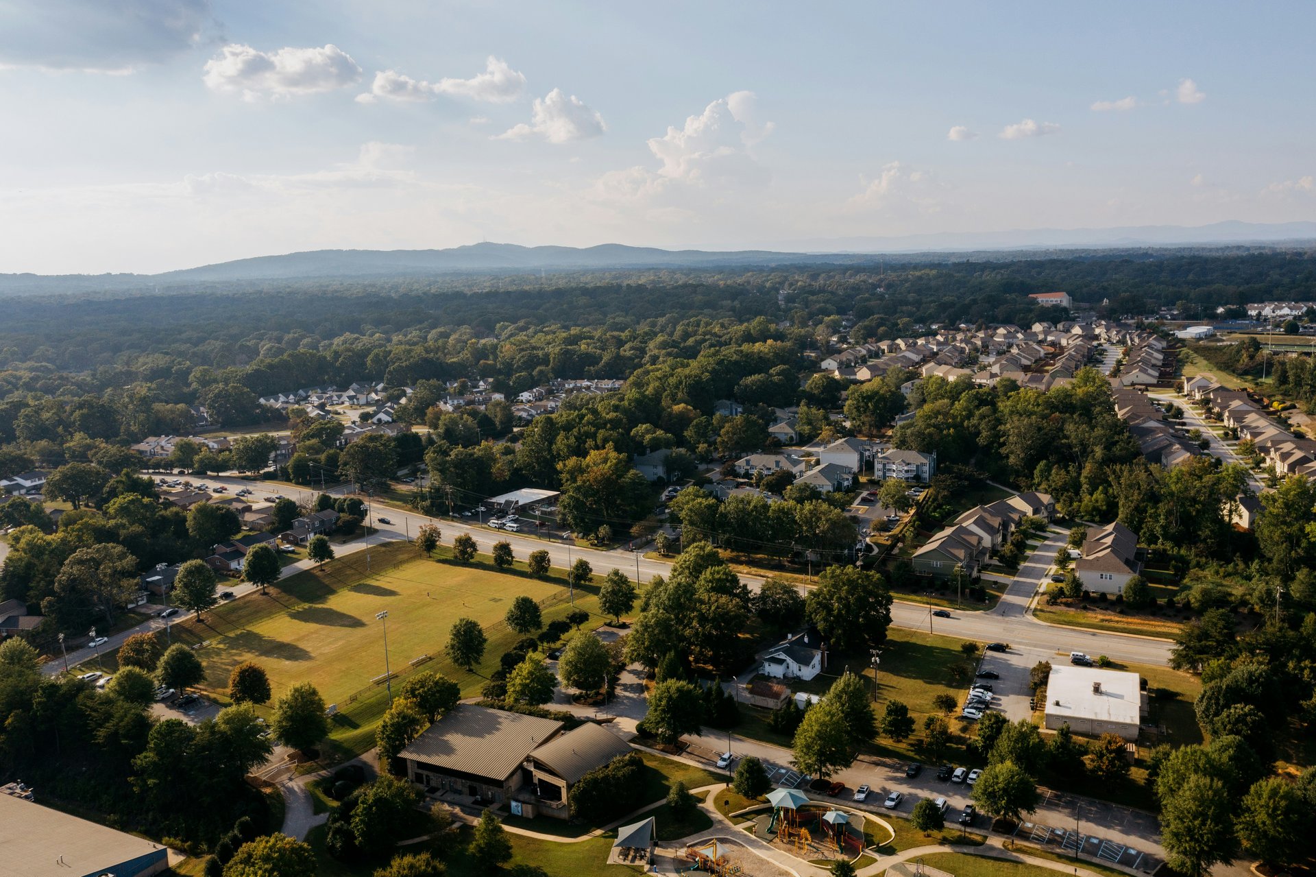 Aerial view of a low-density suburban neighborhood with roads and open space