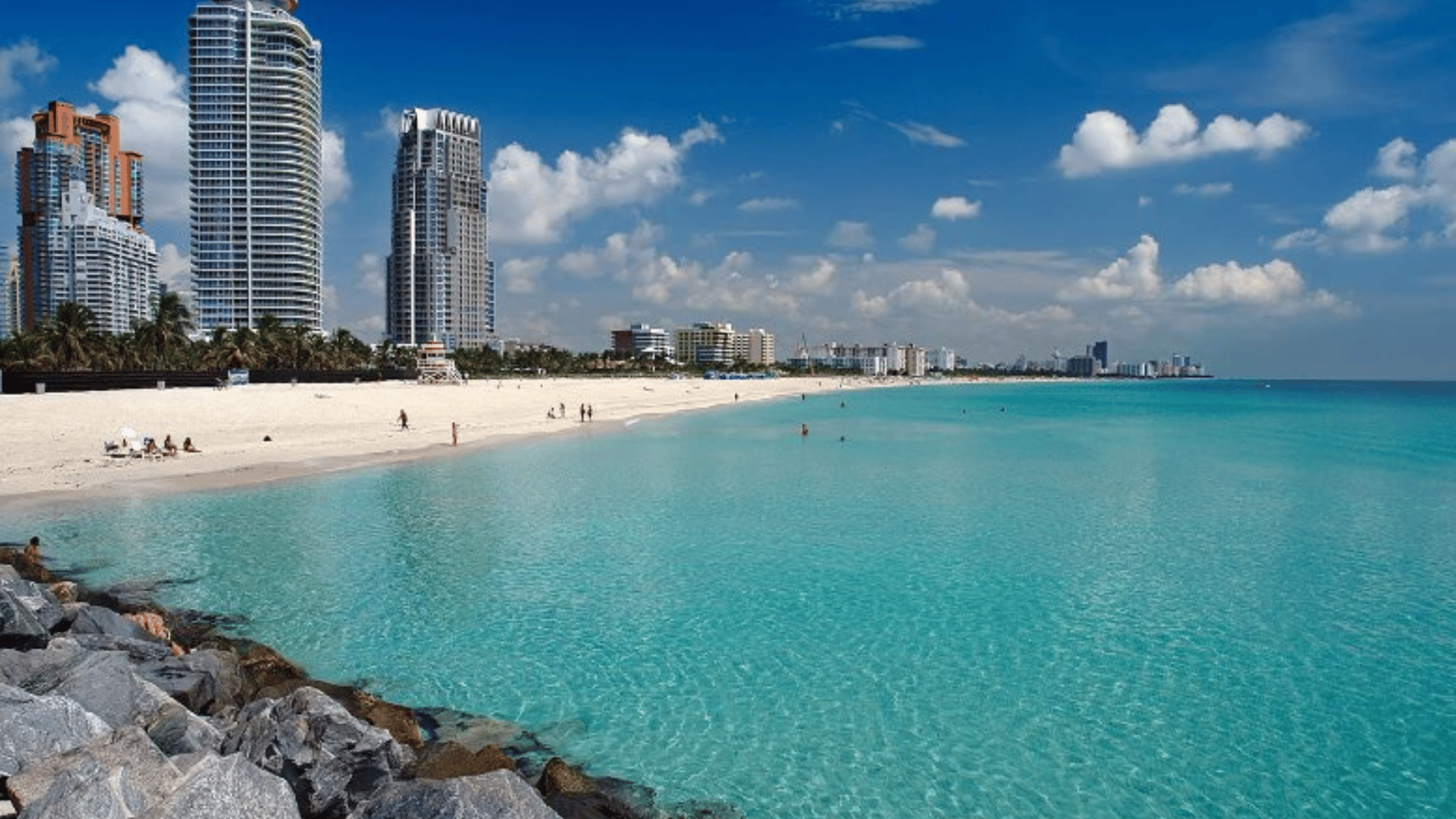 The Edit Real Estate Miami guide showing South Beach's turquoise waters, white sand beach, and luxury high-rise condominiums on arrival day