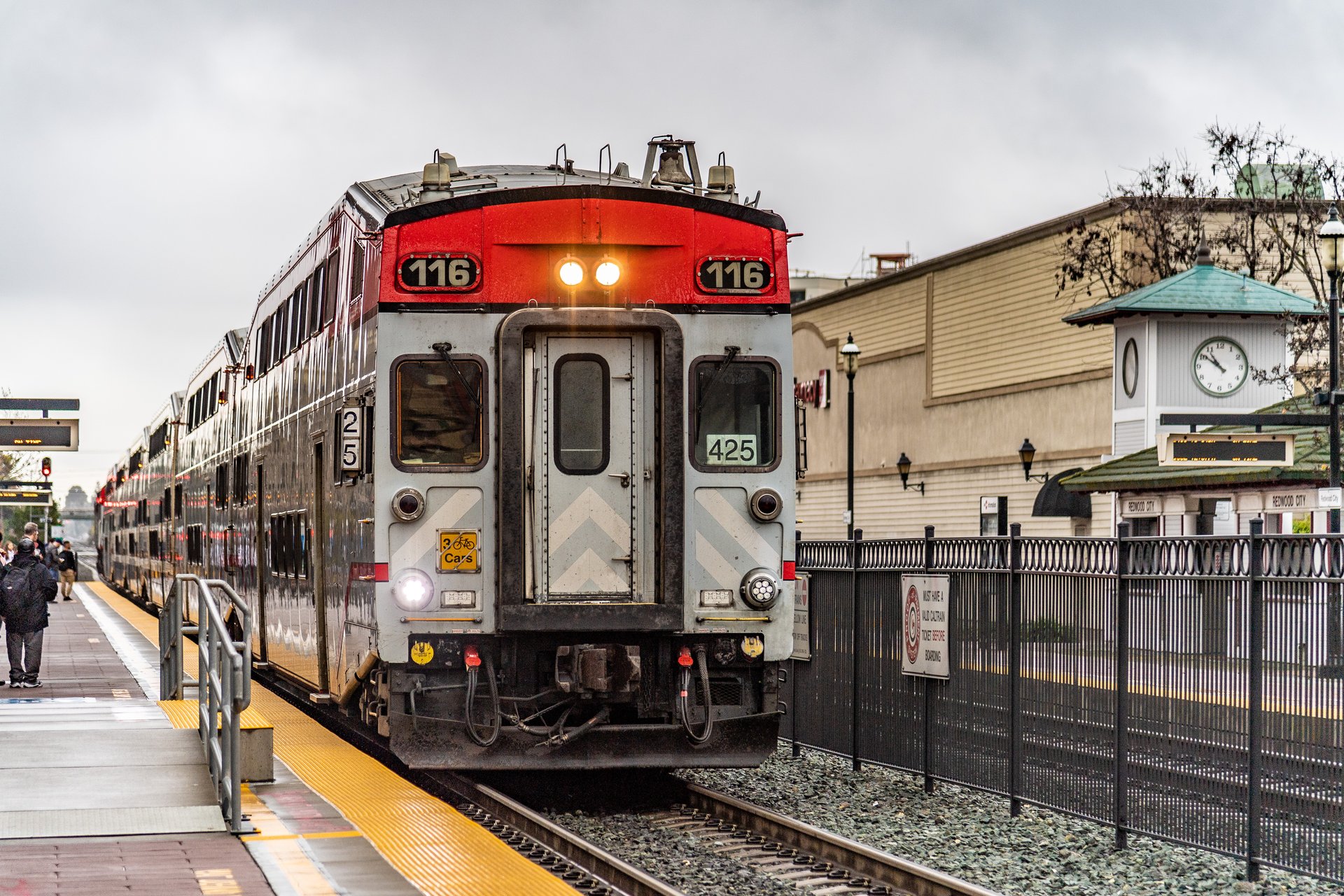 Commuter train stopped at a Peninsula station platform