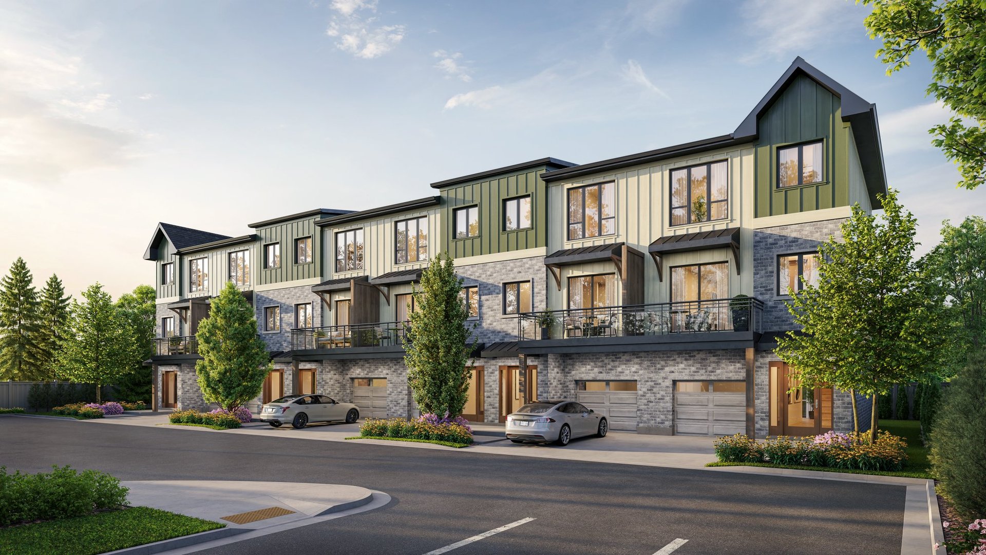 The Ghent Collective townhomes with green siding, stone façades, balconies, and garages.