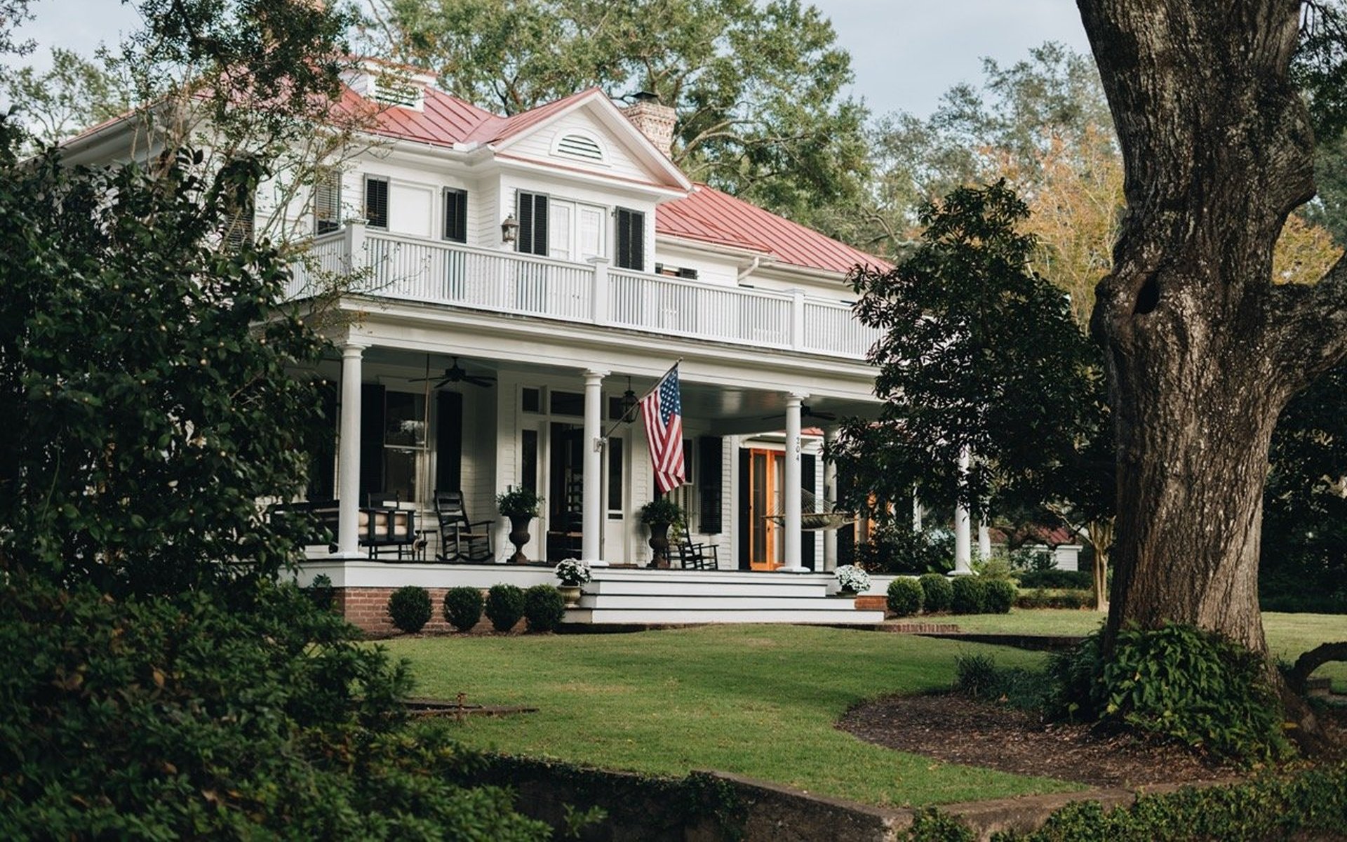Lowcountry home in Mount Pleasant with a columned porch and mature oak trees