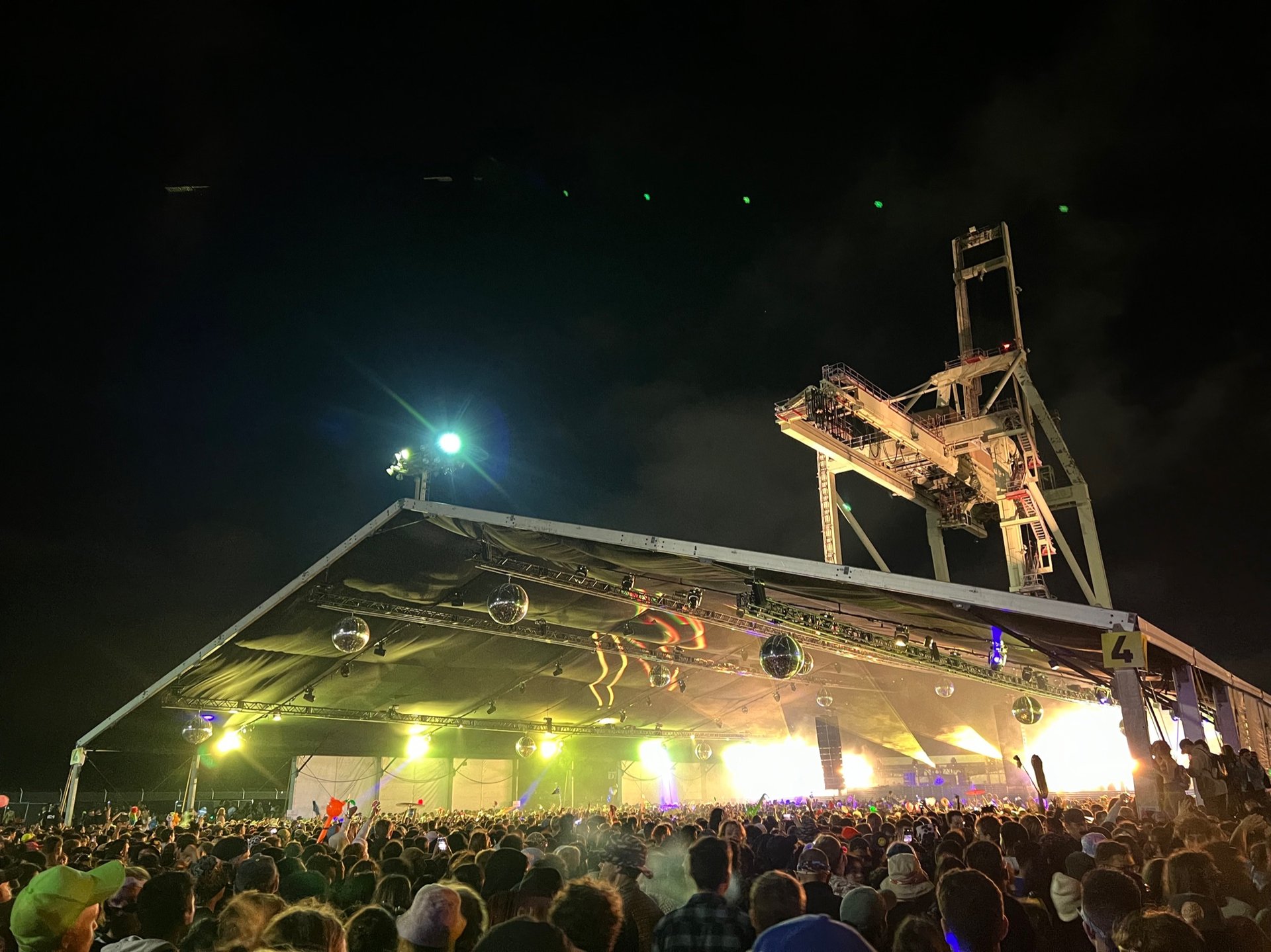 People enjoying a nighttime performance at San Francisco Pier 80