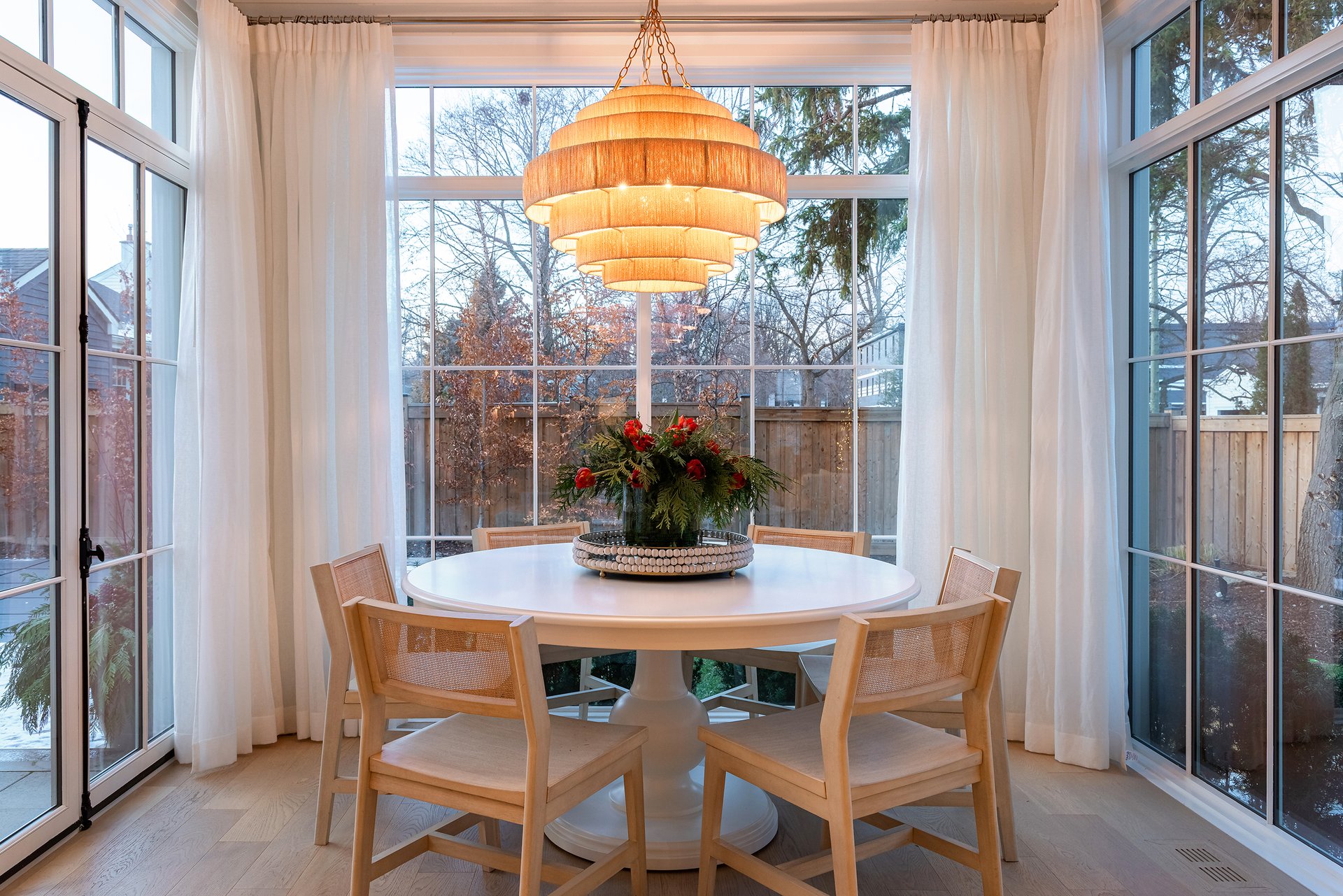 Kitchen design in an Oakville custom home showcasing the popular holiday trend of draped garland over a custom range hood and marble backsplash.