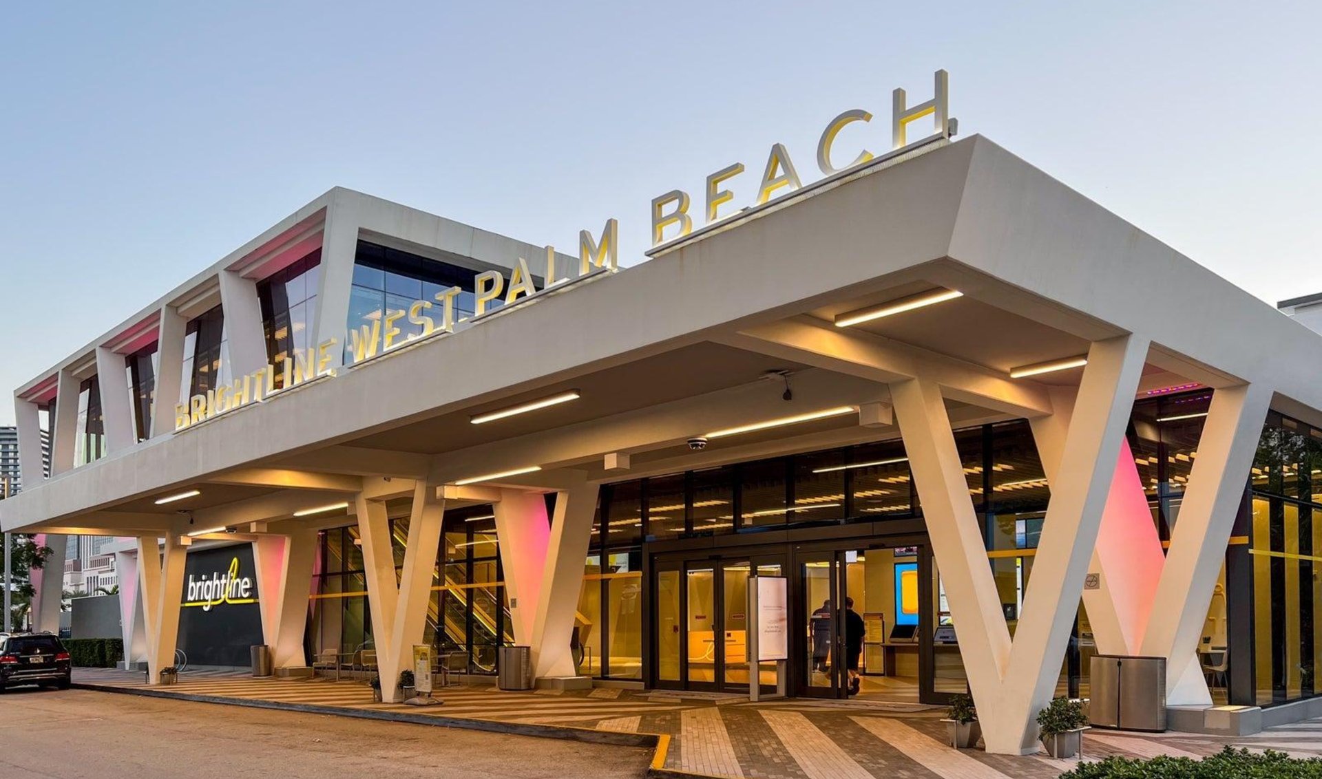 Brightline West Palm Beach station entrance beneath its angular white canopy.