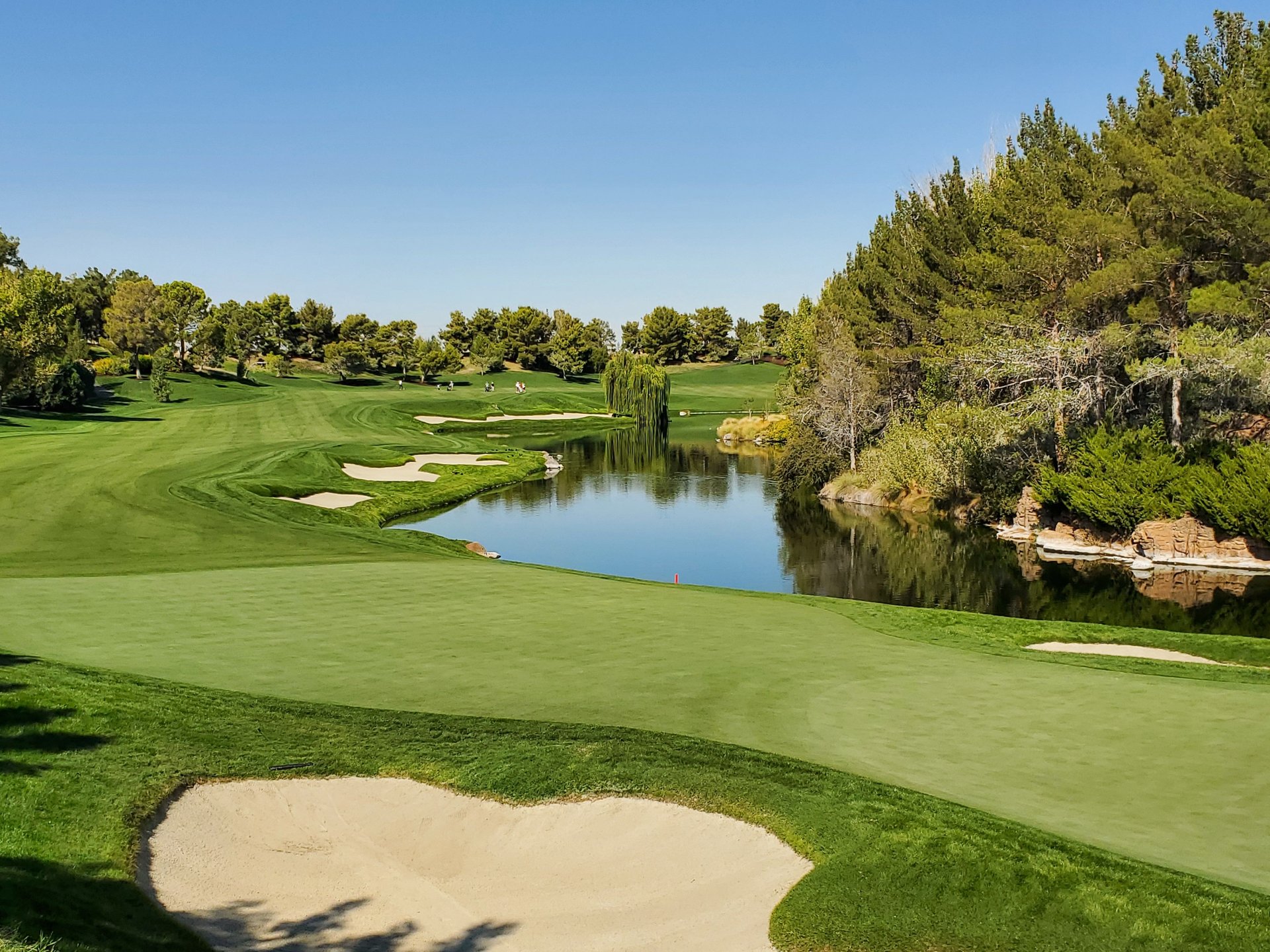 golf course with pond during sunny weather