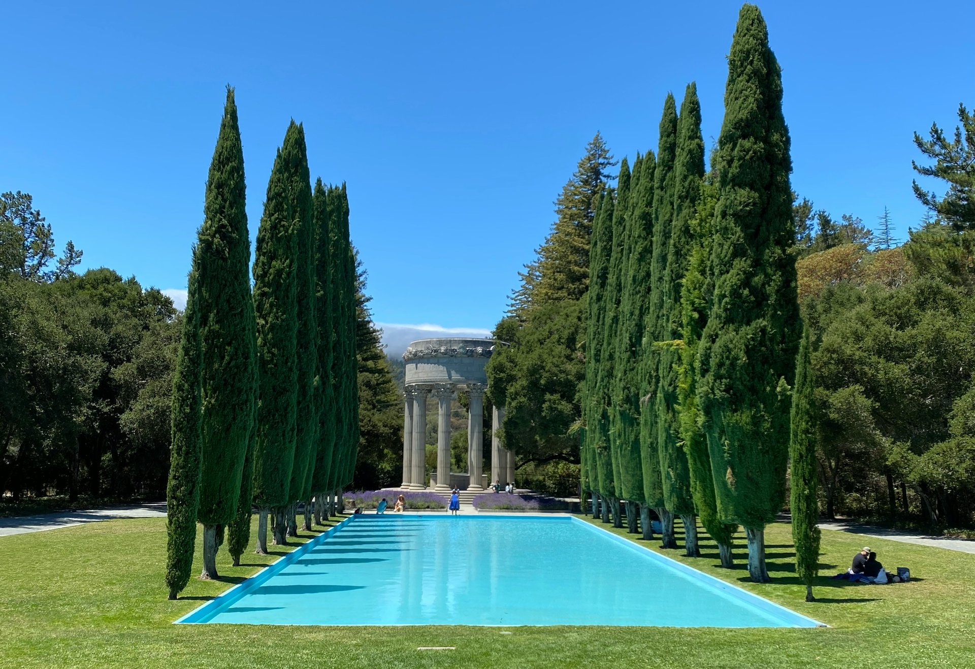 Pulgas Water Temple surrounded by cypress trees, lawns, and a reflecting pool