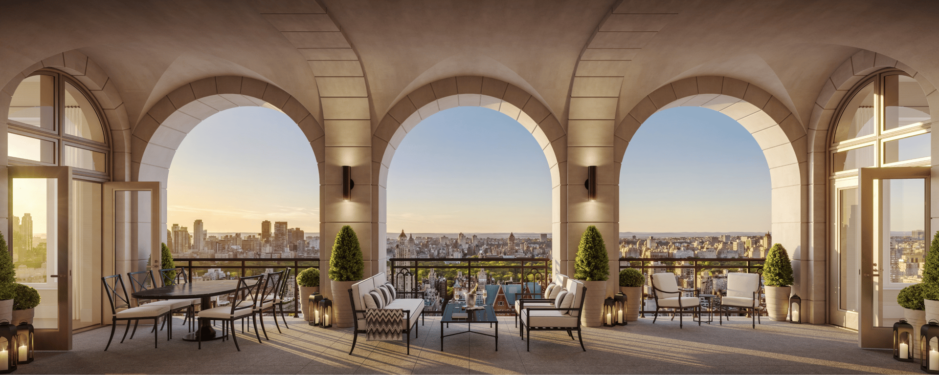 Furnished terrace with stone arches, seating, and a New York City skyline at golden hour.
