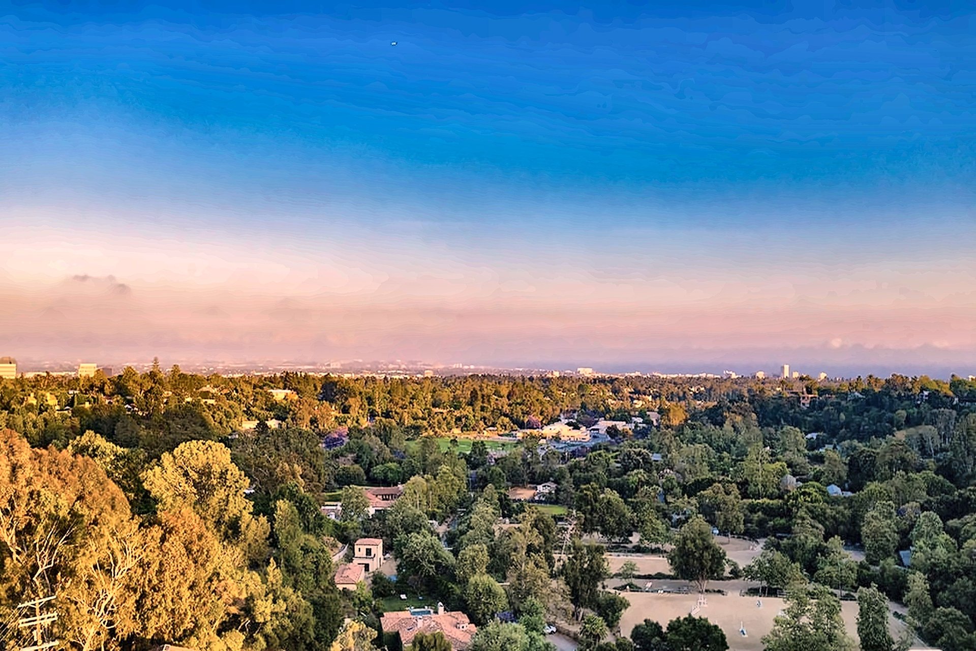 Canyon view from a Brentwood hillside estate toward the coast at sunset
