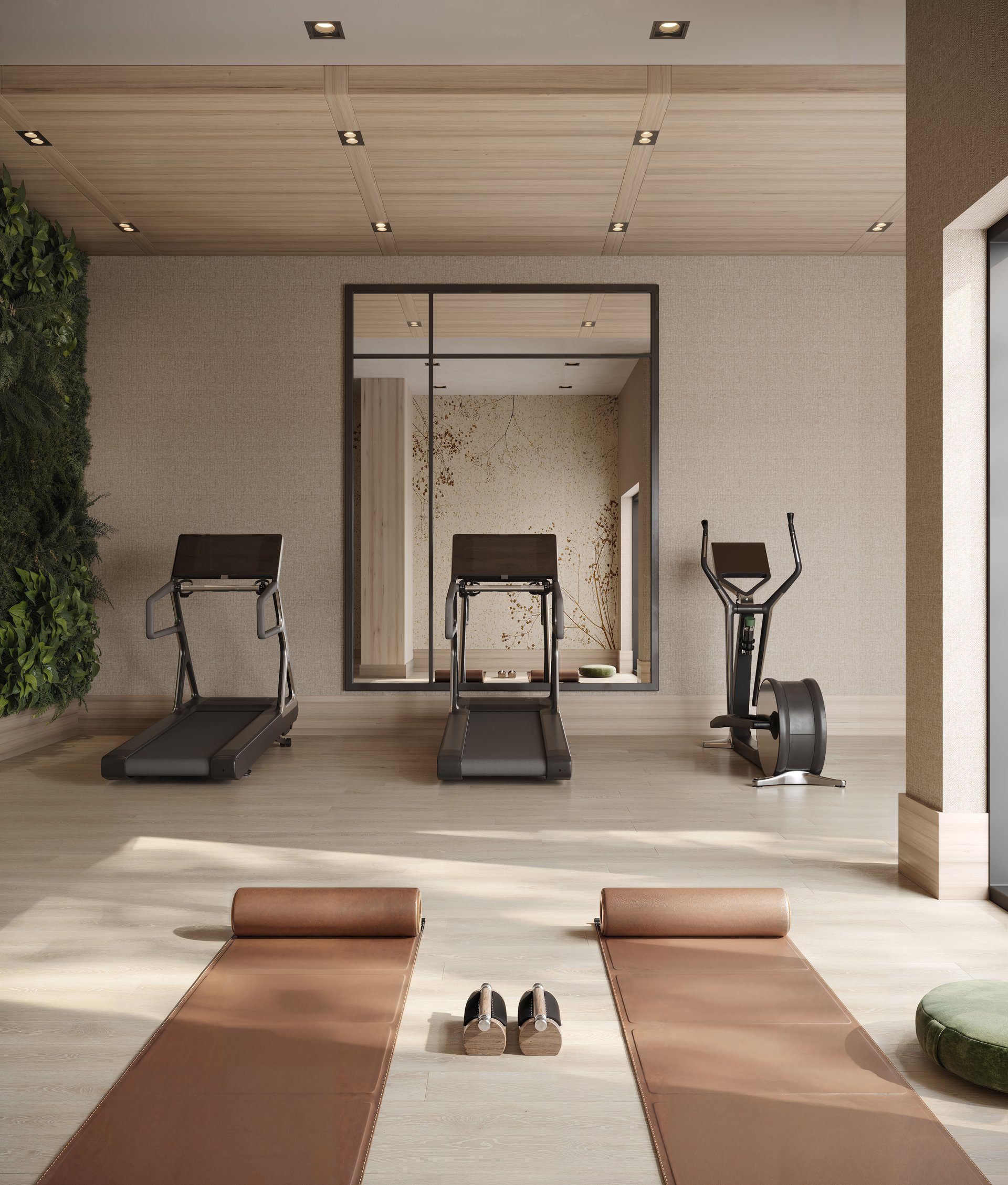 Condo gym with treadmills, an elliptical, brown exercise mats, and a leafy green wall.