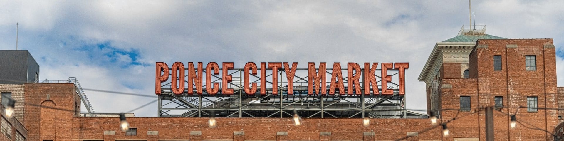 Ponce City Market’s rooftop sign above its historic red-brick buildings.