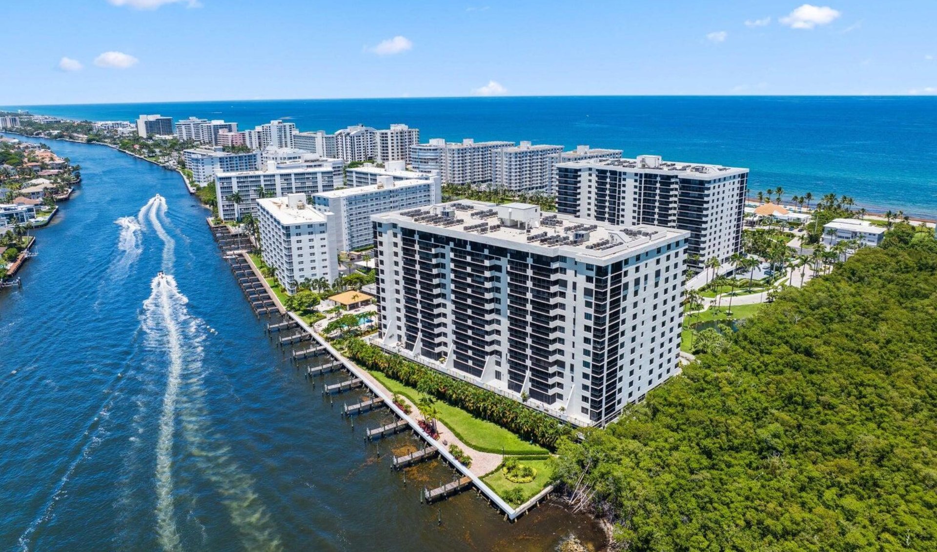 Waterfront condominium towers between a boat canal and the Atlantic Ocean
