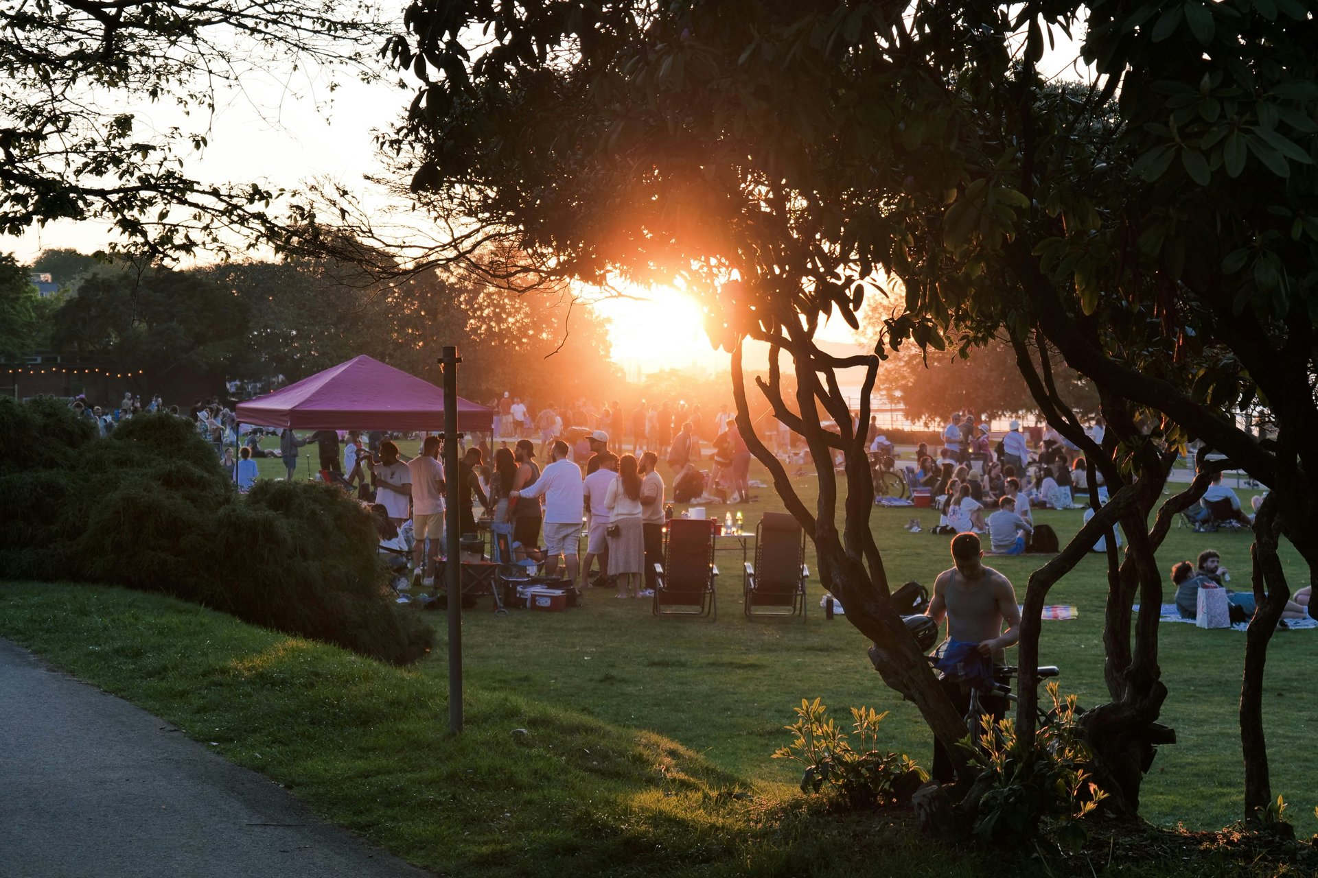People gathering at an outdoor community event in a park