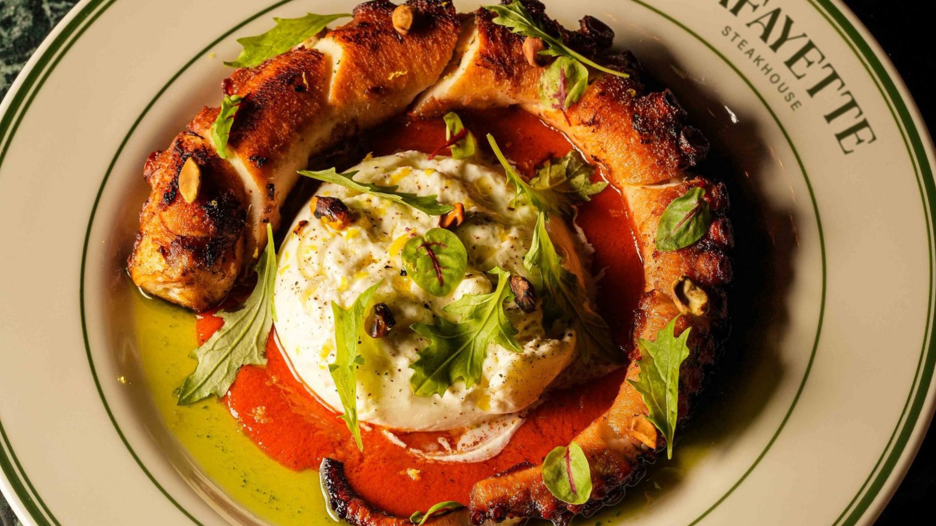 Grilled peach and fresh burrata cheese with arugula and balsamic reduction on Lafayette restaurant plate