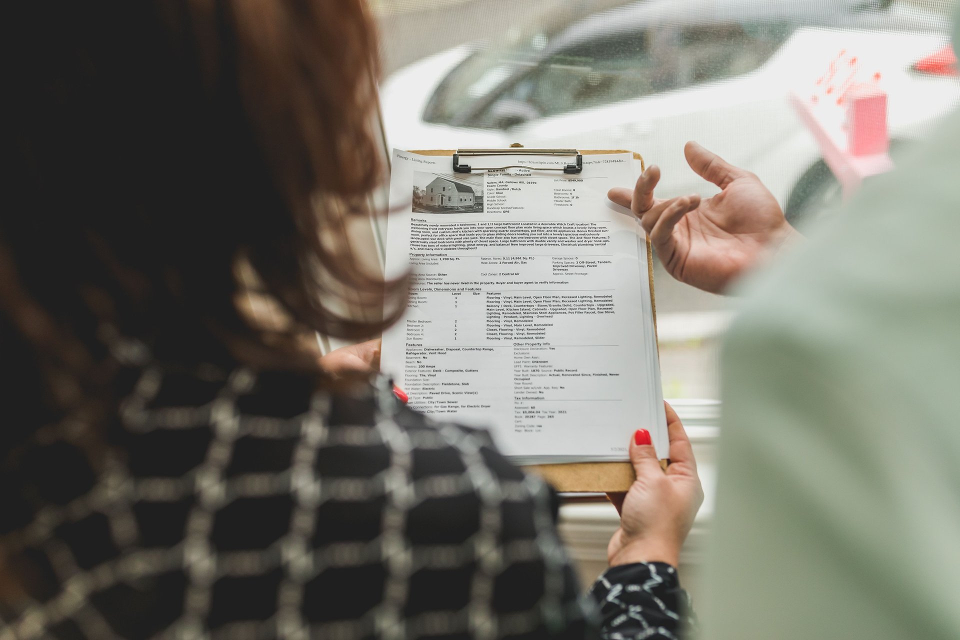 a person reading and holding document on a clipboard