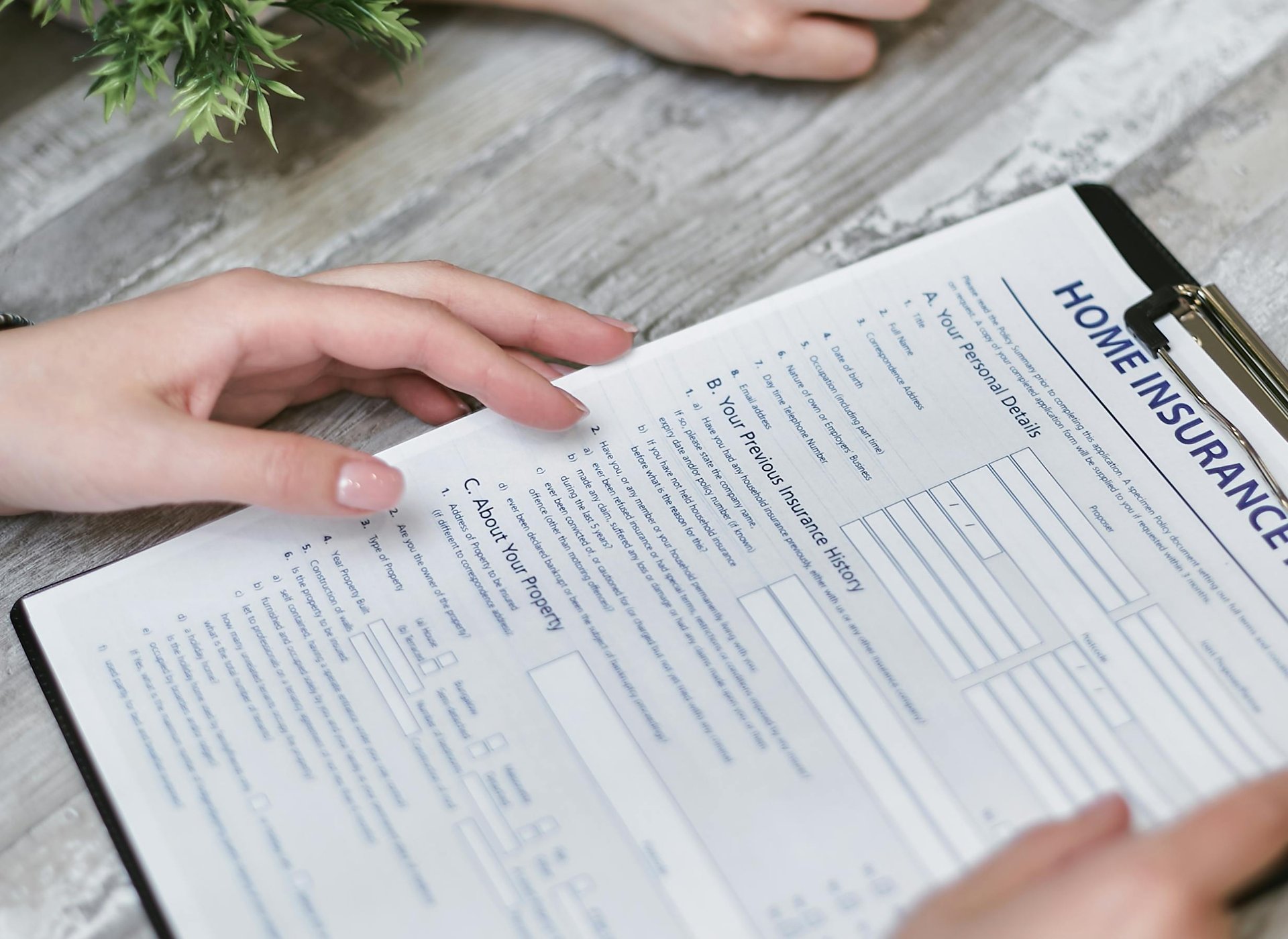 a person holding out insurance forms
