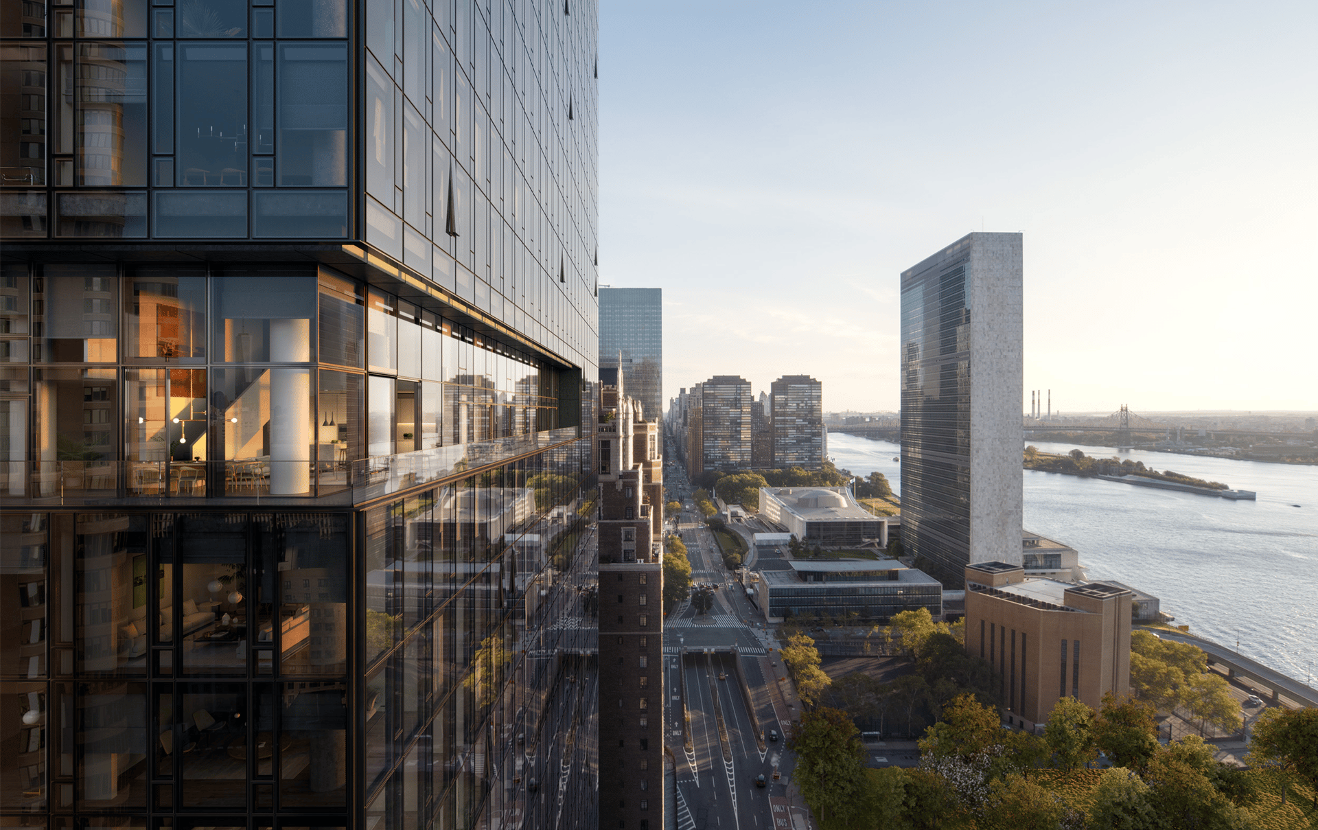 Glass residential tower overlooking the East River and Manhattan skyline in warm evening light.