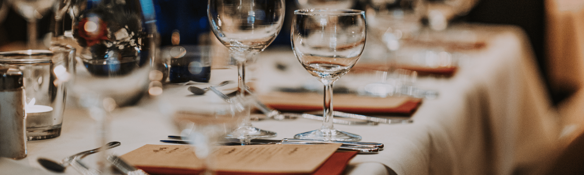 a table with glasses and plates