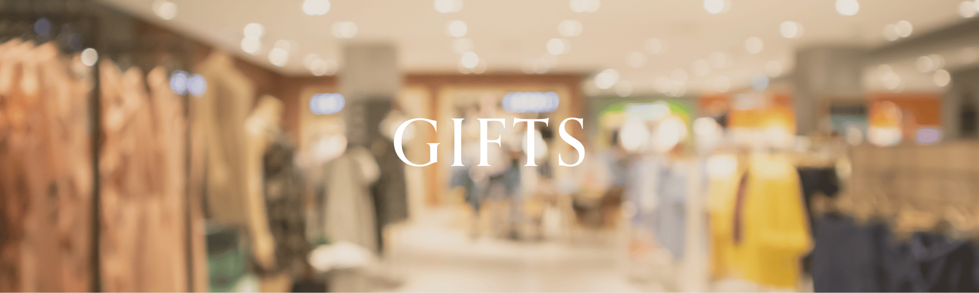 A blurred image of a retail store interior with clothing displays and the word "GIFTS" prominently featured in the foreground.