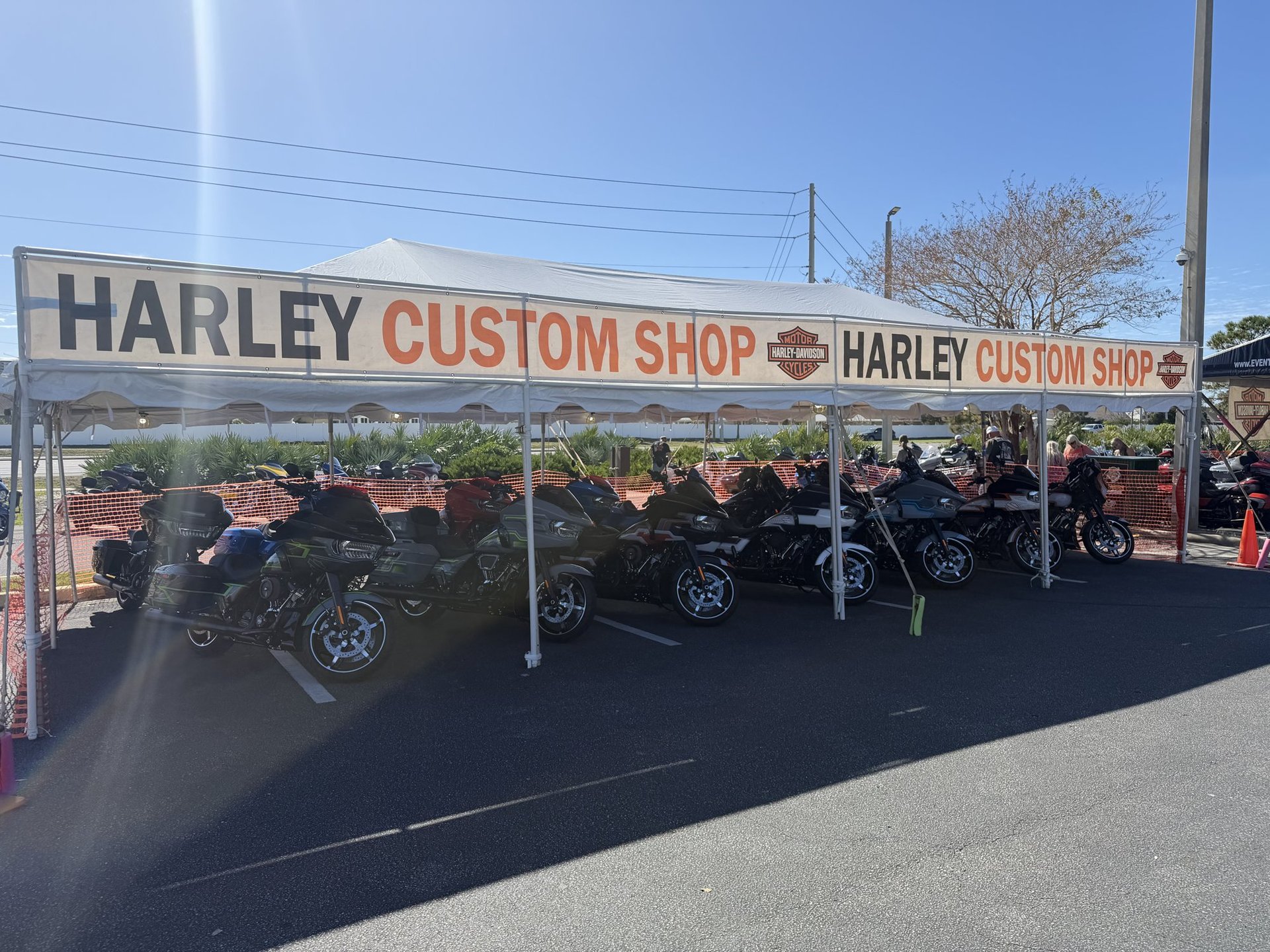 Custom Harley-Davidson baggers parked under the Harley Custom Shop tent in Panama City Beach