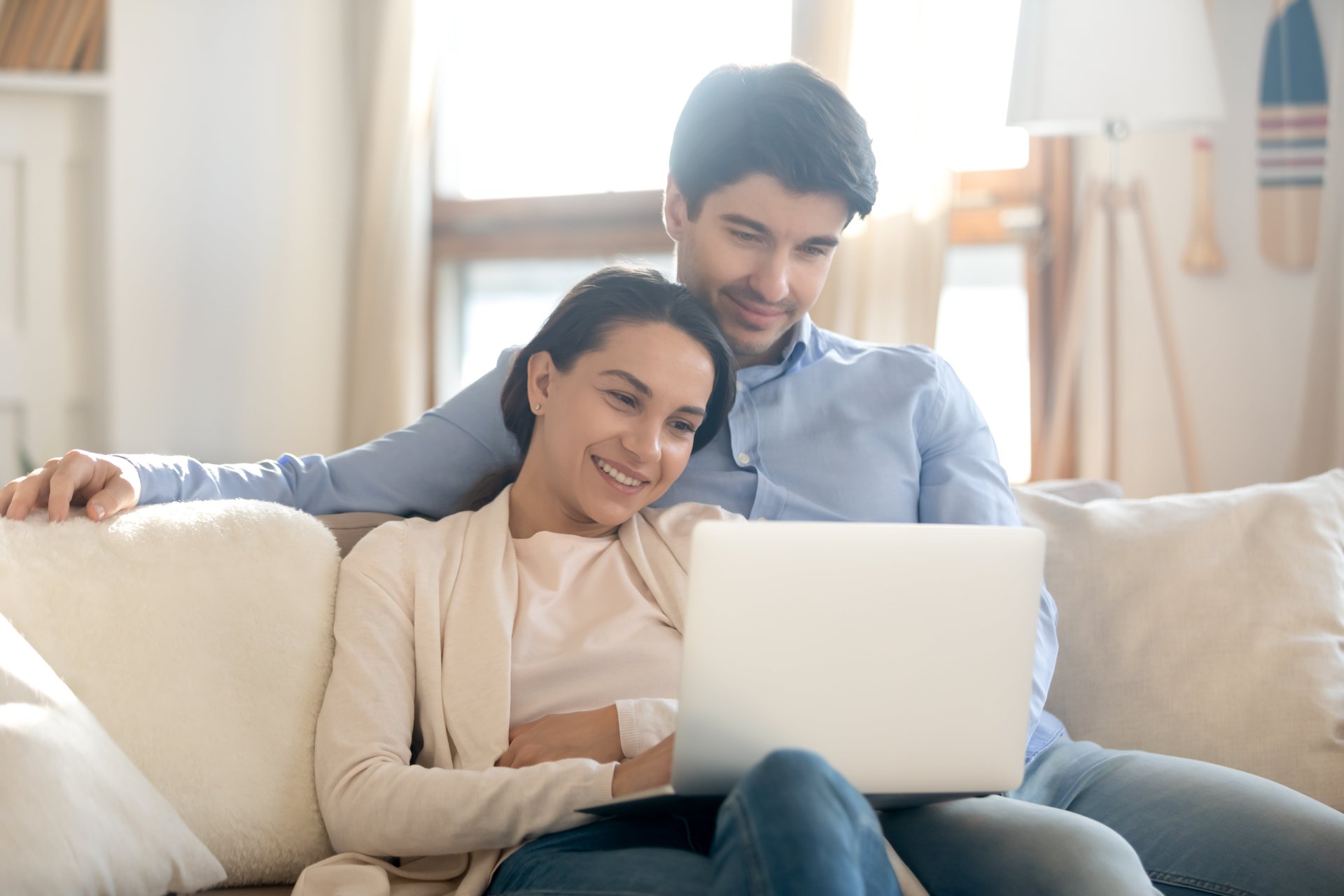 Young homebuyers viewing a virtual property tour together on a laptop—perfect visual for real estate agents promoting video marketing, 3D tours, and digital walkthroughs.