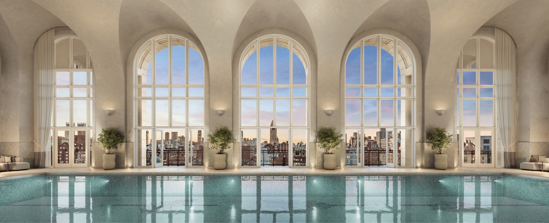 Indoor pool beneath arched windows overlooking the city skyline.