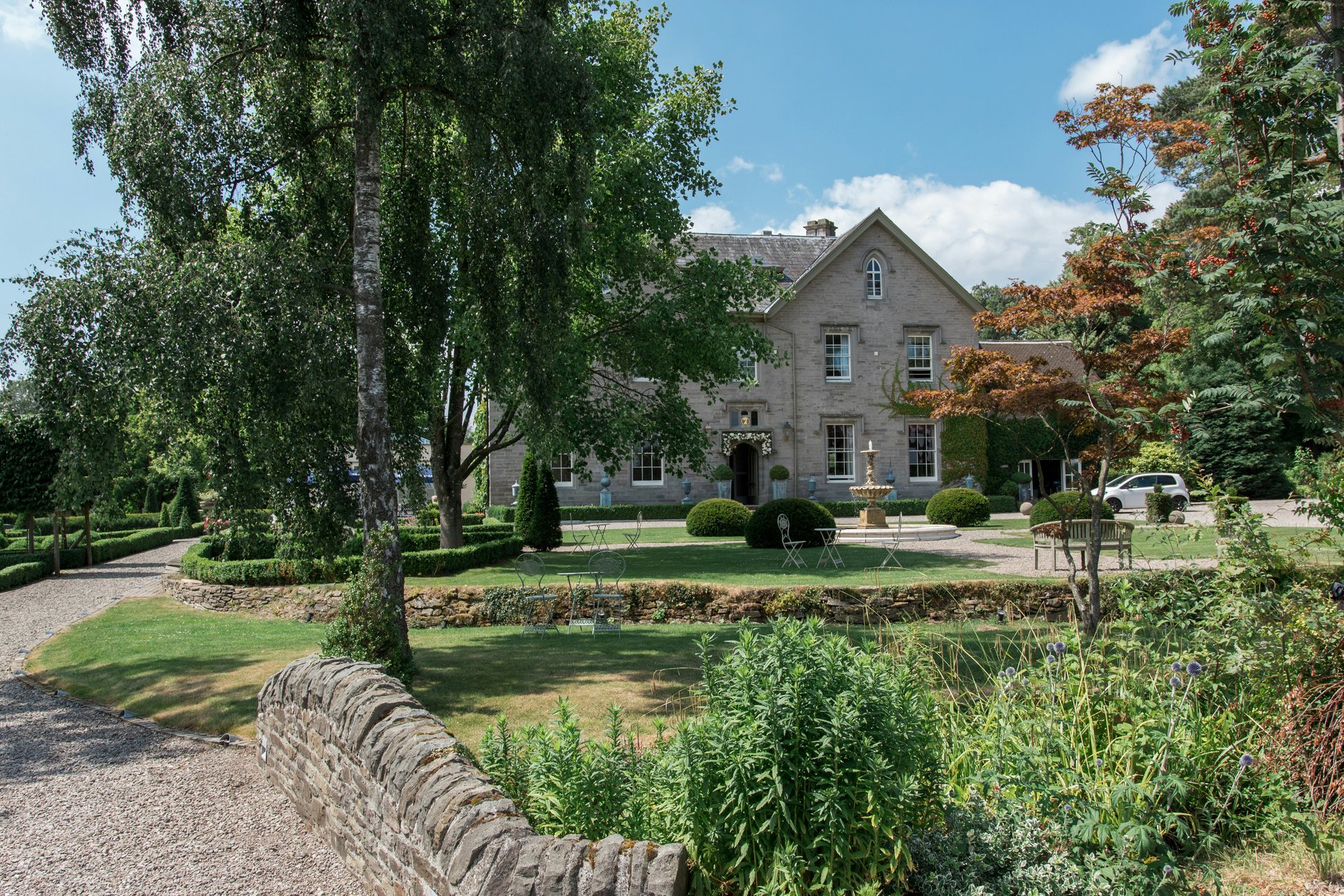 Large residential home on a spacious landscaped lot with mature trees