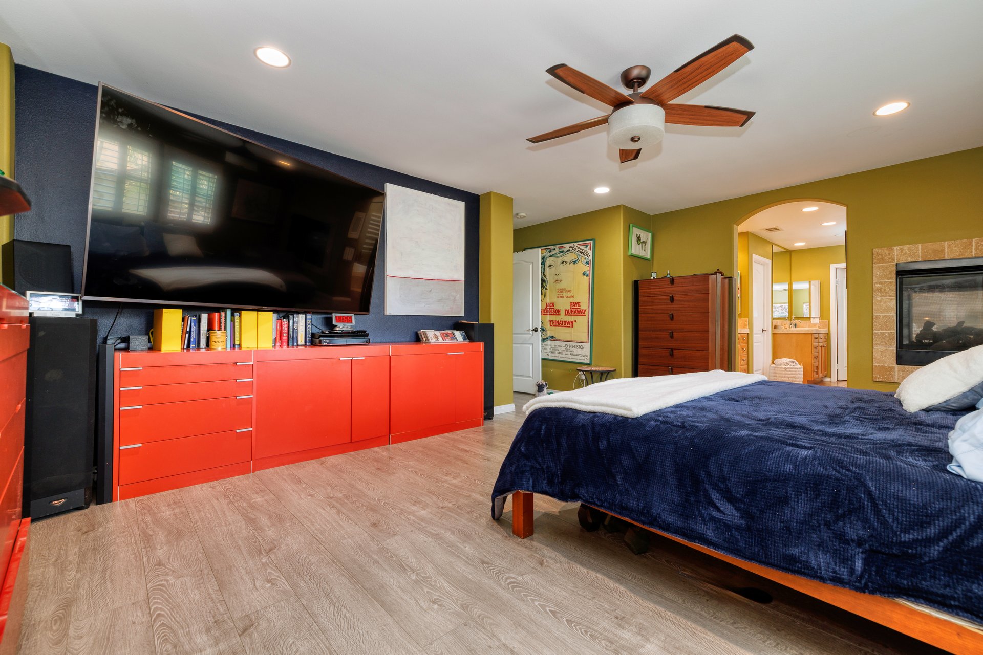 Upstairs bedroom with ceiling fan and natural light