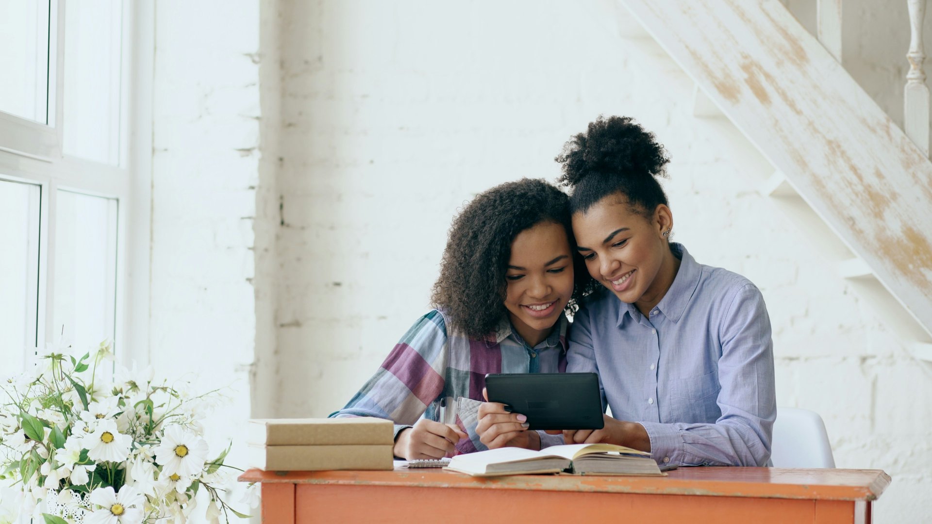 Student and parent working together on schoolwork at home
