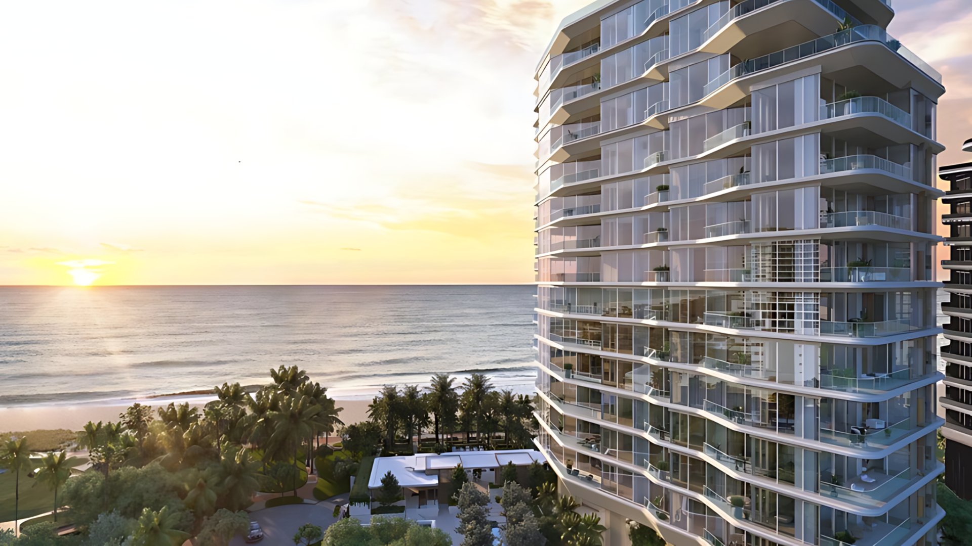 Modern luxury beachfront condominium tower at sunset in Miami - The Edit Real Estate