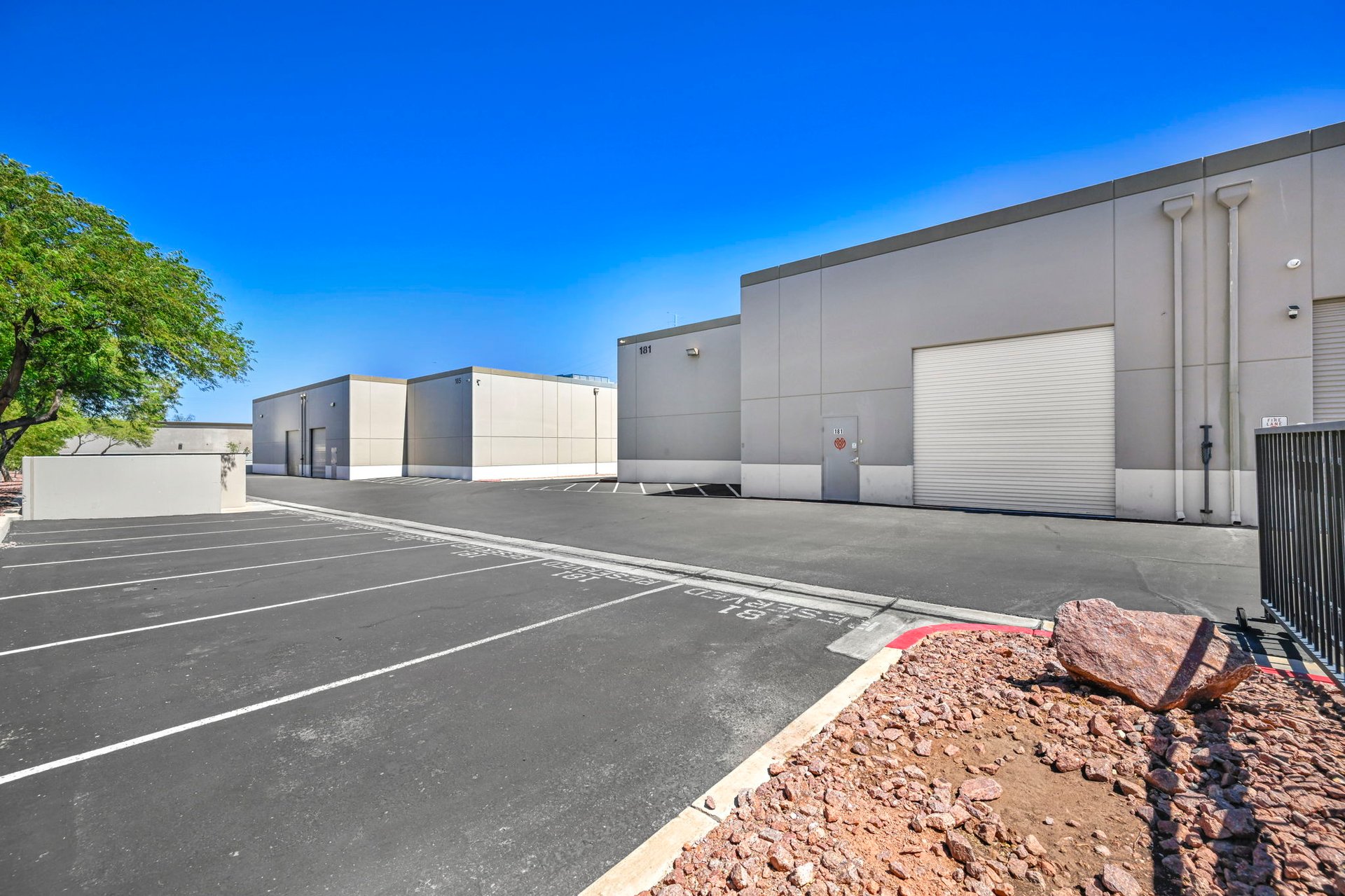 Commercial building at 181 N. Gibson with a large roll-up door and marked parking area.